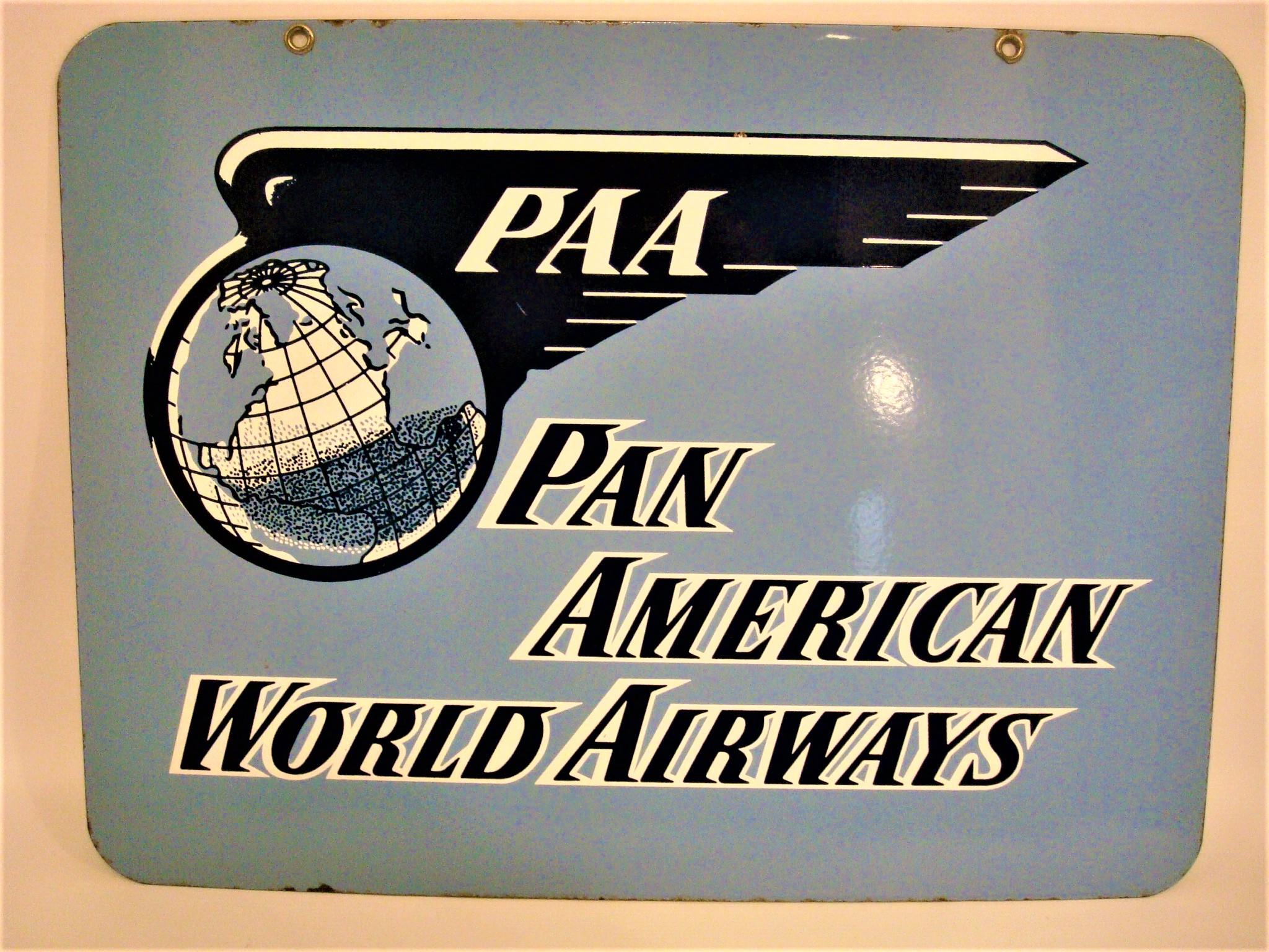 Enseigne en porcelaine et émail de Pan American World Airways, datant du milieu du 20e siècle. Ce panneau est pour Pan American World Airways. Les couleurs de l'enseigne sont le bleu clair, le bleu foncé et le blanc. Le texte sur le panneau indique