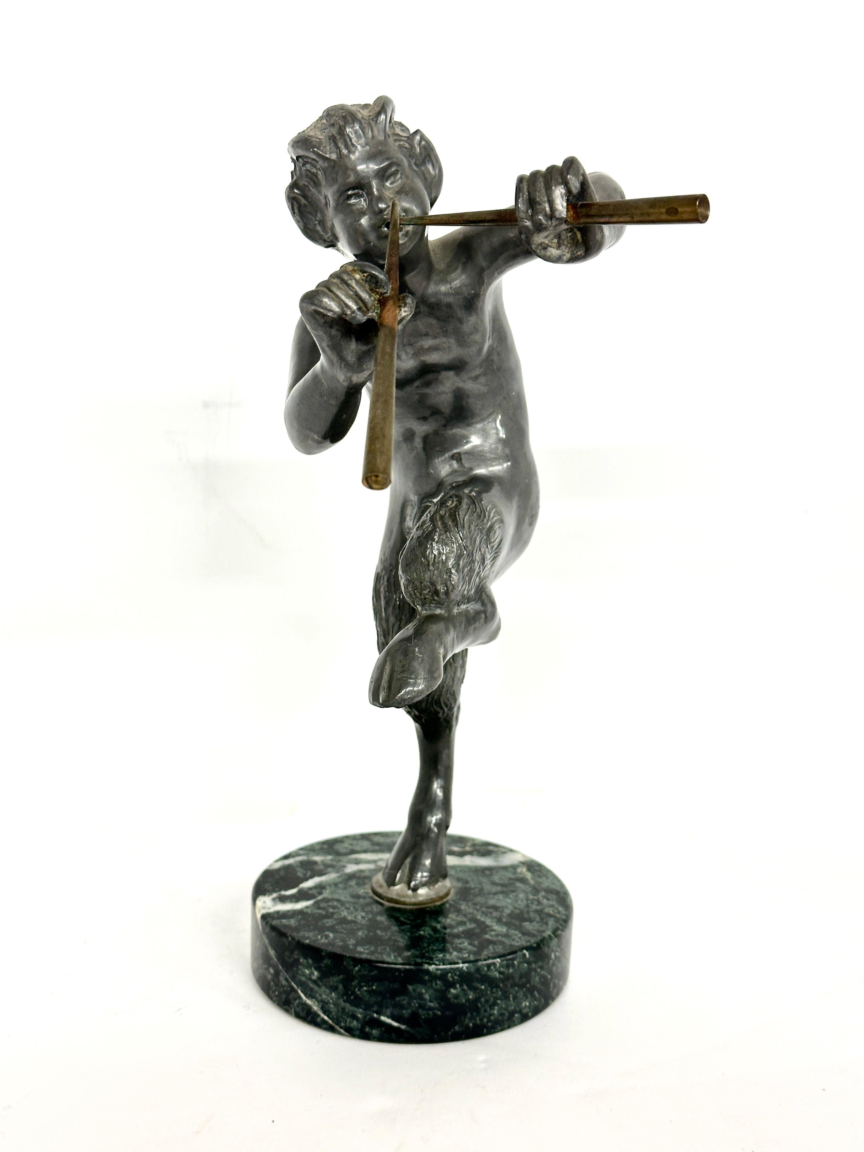 A nice metal sculpture of Pan playing his pipes or flutes. neoclassical grand tour sculpture after the antique. This beautifully cast and finished example is mounted on a round marble base. Likely mid 20th century brought back from a European Tour.