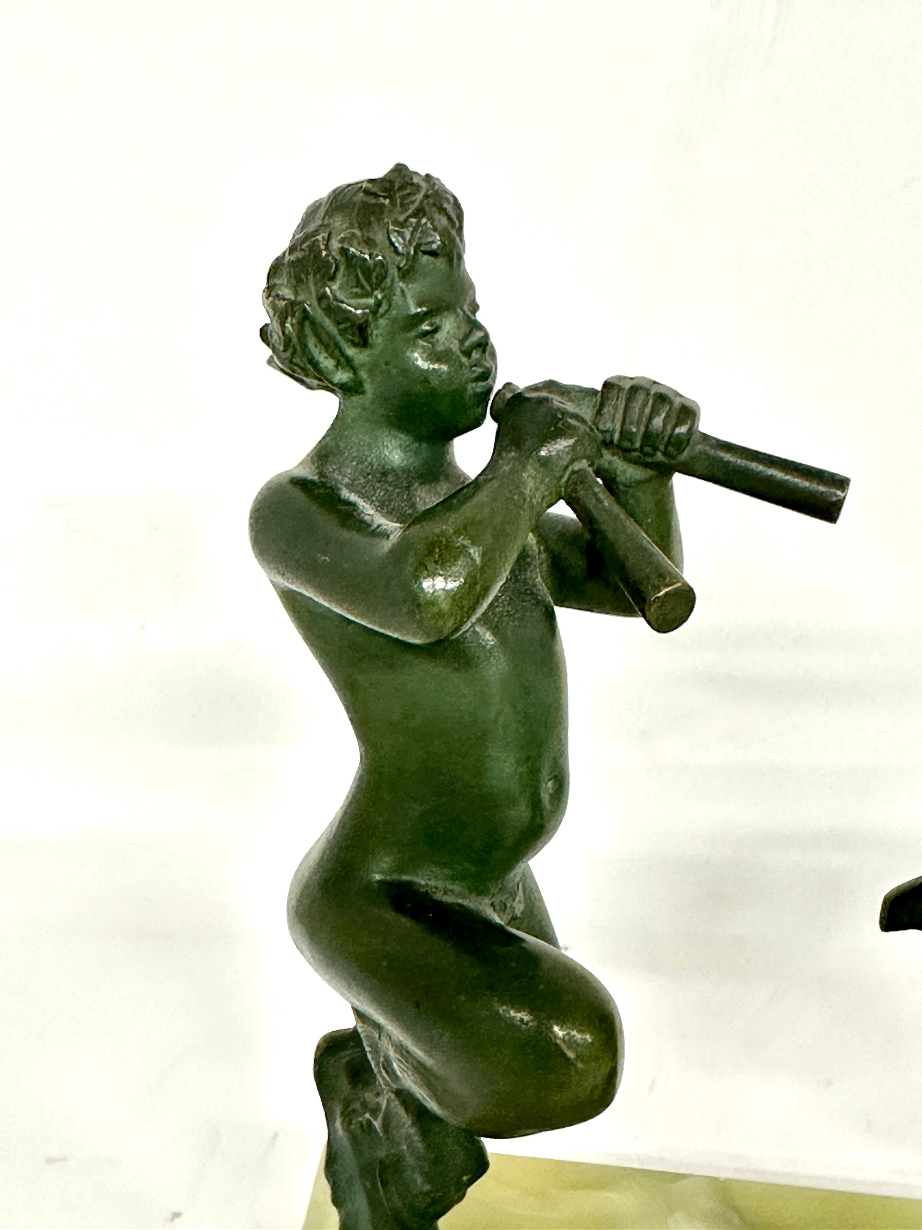 A whimsical wonderfully detailed metal sculpture of Pan playing his flutes to 2 dancing goats. Mounted on a dyed alabaster base. The sculpture is likely bronze with nice green patination. Out of the same estate as a group of Neo Classical Grand Tour
