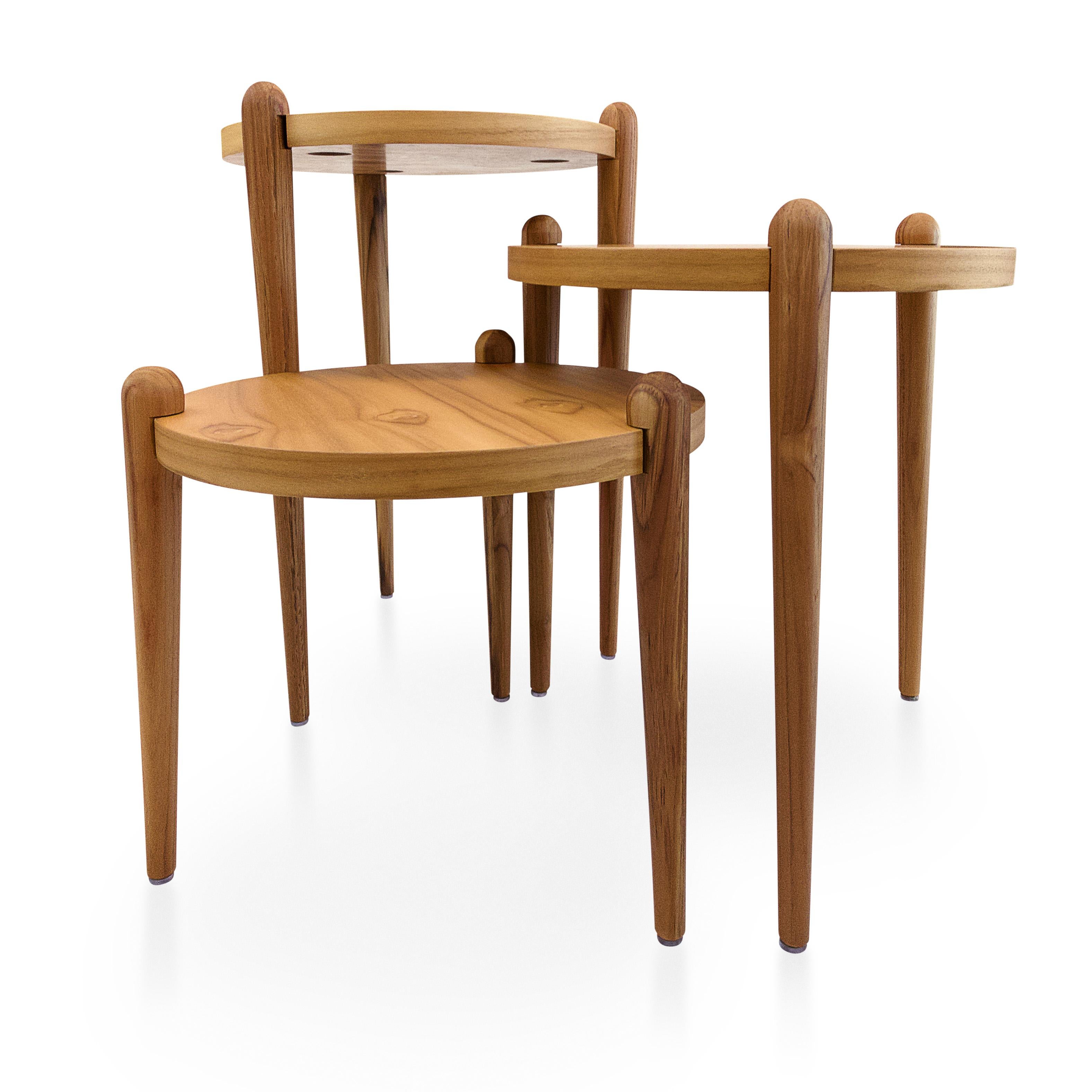 A set of three accent tables designed by Sérgio Batista for Uultis, made of teak wood, with circular tops and cone shaped legs. *Please check availability prior to purchase*.

This elegant set of three accent tables, designed by Sérgio Batista for