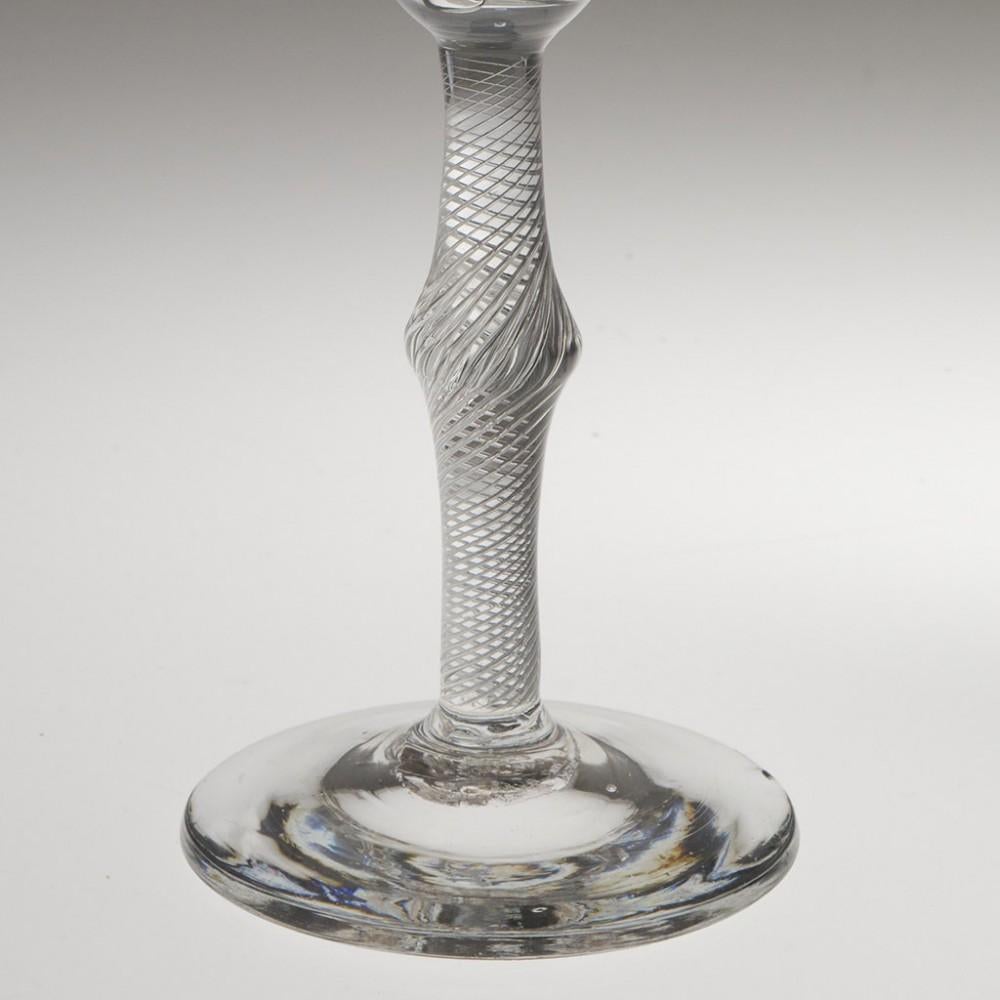 Heading : Pan topped air twist stem Georgian wine glass
Period : George II - c1750
Origin : England
Colour : Clear
Bowl : Pan top
Stem : Multi spiral air twist with central angular knop
Foot : Conical
Pontil : Snapped
Glass Type : Lead
Size :  18cm