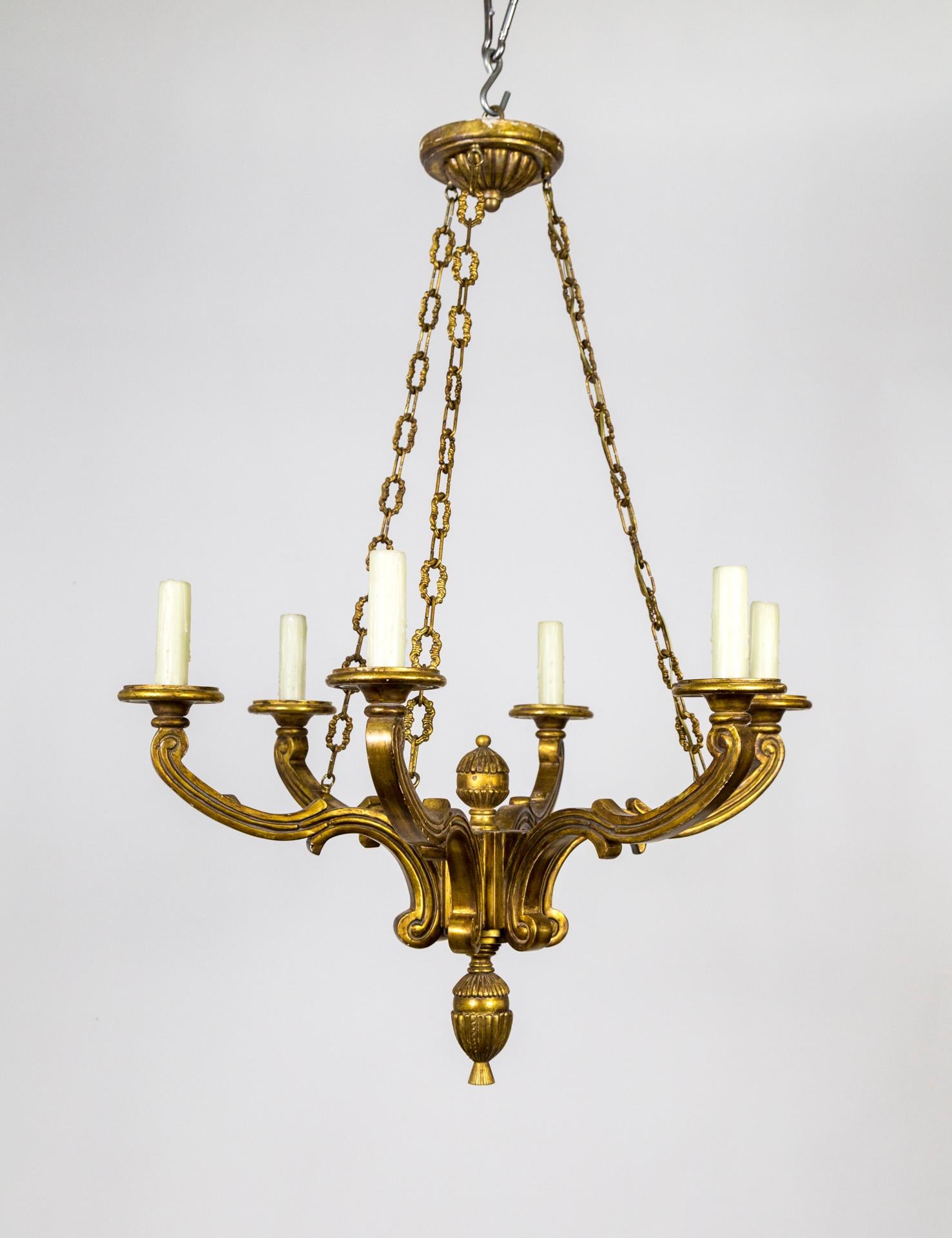 A vintage, gilt, carved wood chandelier with 6 arms in Regency Style by Panache Designs for Michael Taylor.  A timeless design. Newly rewired with matching decorative brass chain and canopy. 1980s.
Pair available, sold individually. 
36” height x
