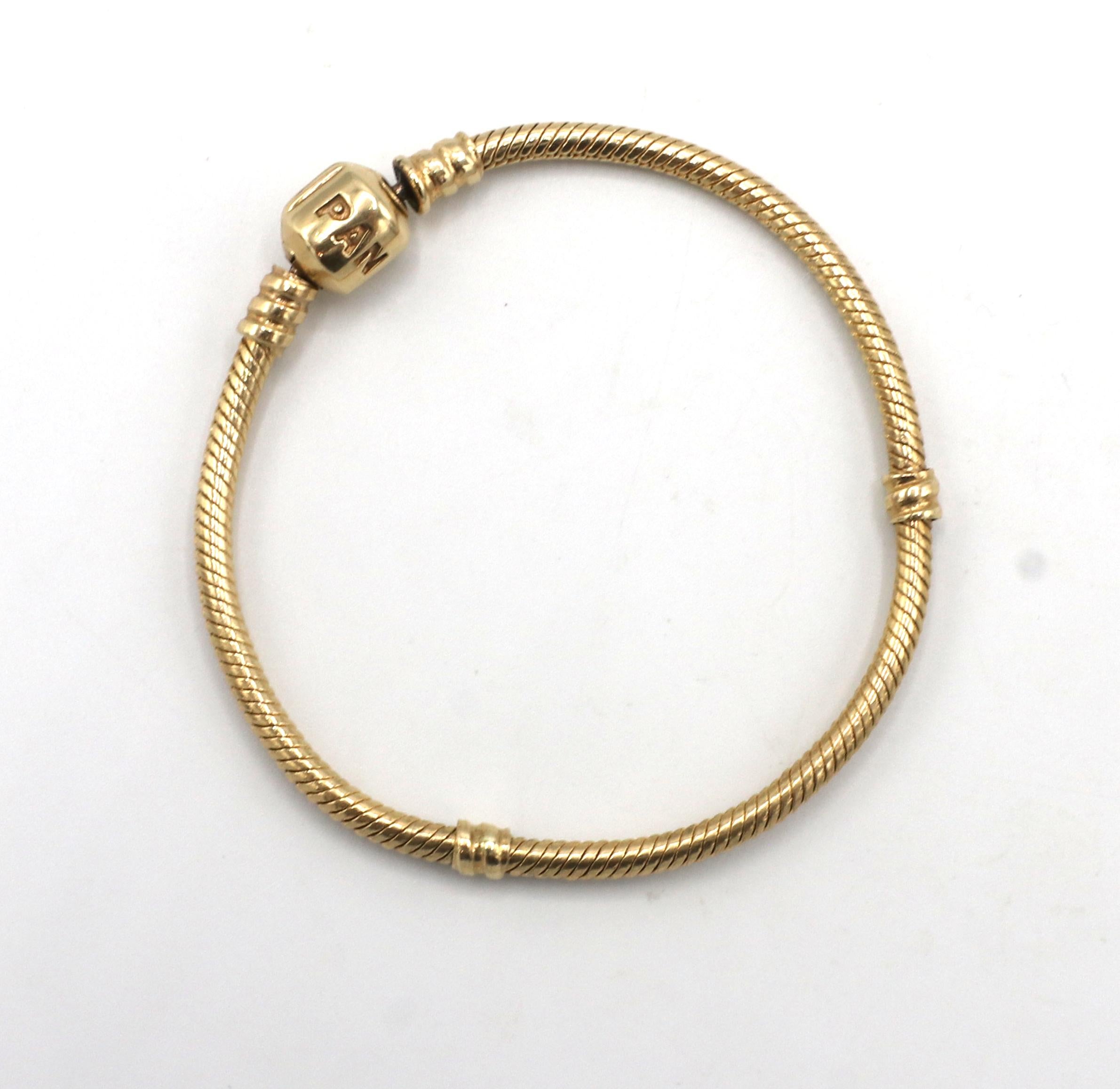 Pandora 14 Karat Gold Moments Snake Chain Bracelet 
Metal: 14k yellow gold
Weight: 15.4 grams
Length: 6.7 inches
Width: 3mm
Retail: $1,925 USD
