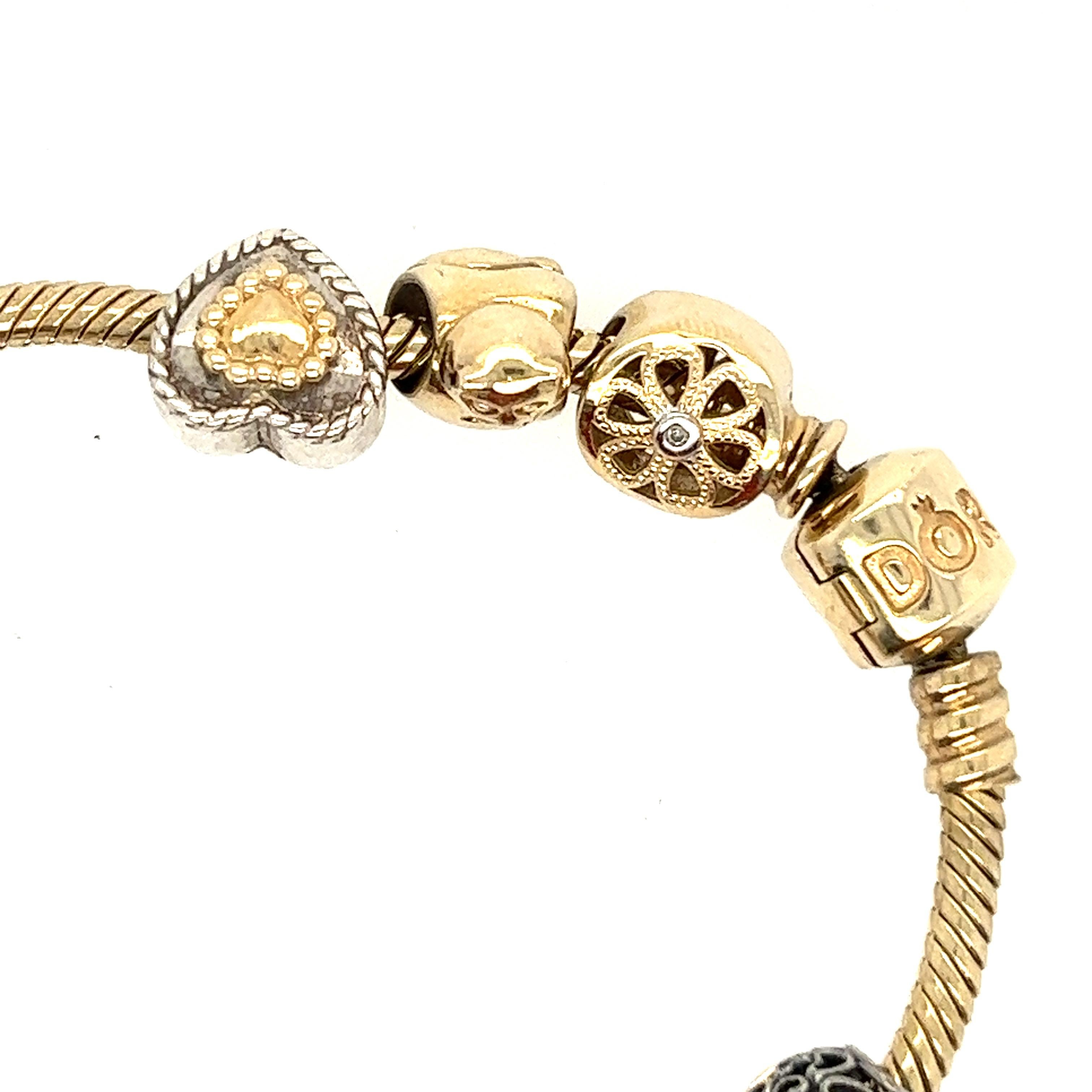 This 14k snake chain charm bracelet is perfect to add to your Pandora collection. It features Pandora' iconic barrel clasp and a threading system allowing you to add charms with ease. Includes bracelet, separators & 10 charms.

Charms include: Gold
