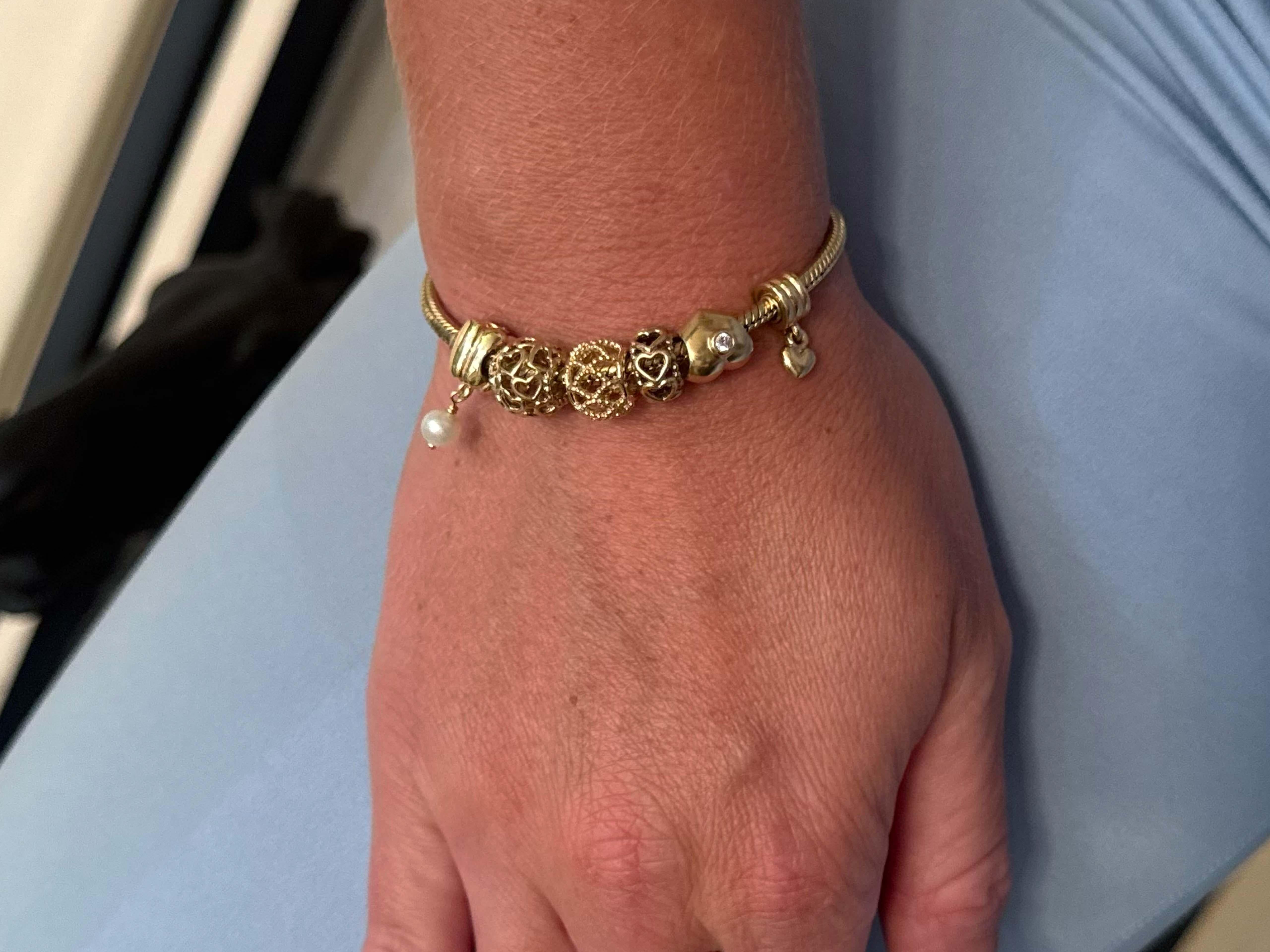 Solid 14k gold Pandora charm bracelet with 6 bead charms. Weighs 30.4 grams. Bracelet circumference is about 7.07