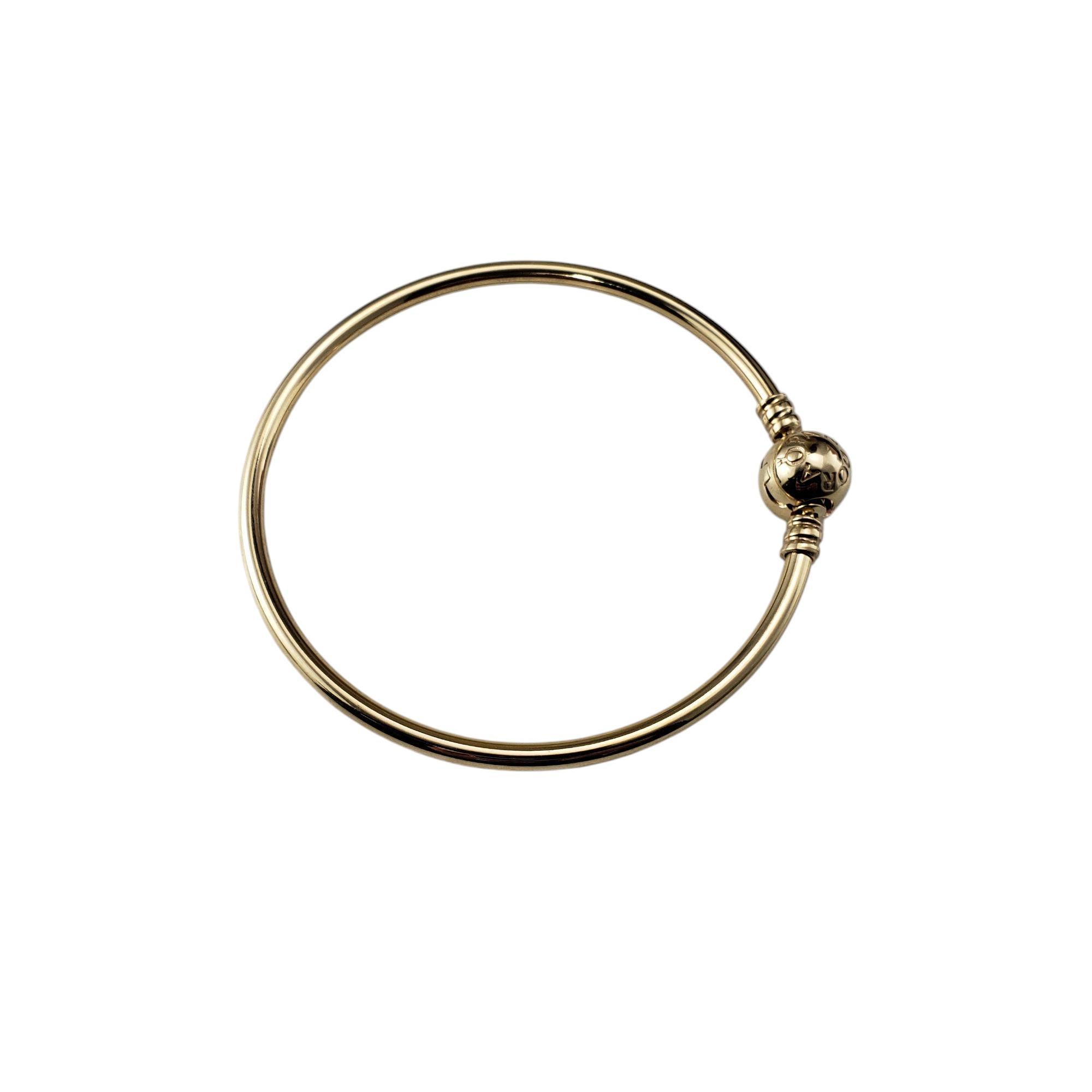 Pandora 14K Yellow Gold Bangle Bracelet-

This 14K yellow gold bangle features a sleek, hand- finished design polished to a high shine. Its minimalist aesthetic is accentuated by the classic Pandora logo ball clasp, ensuring both stye and security.