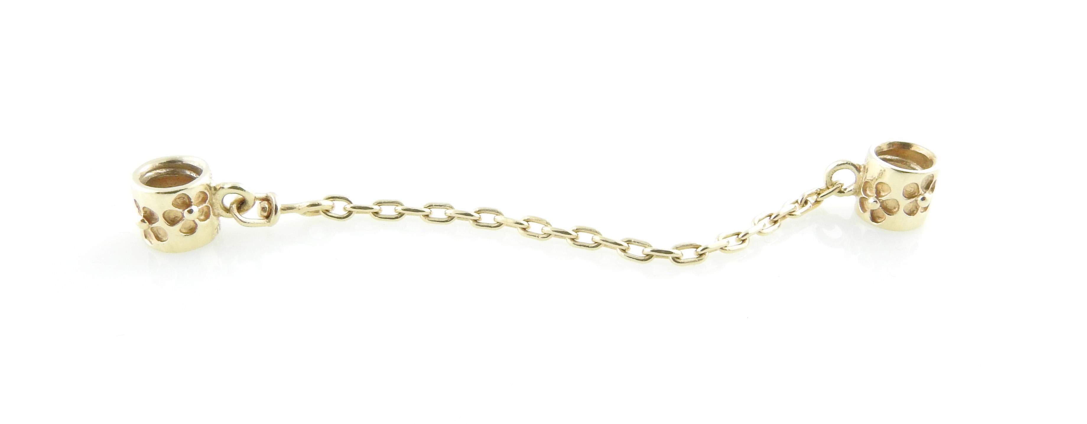 Authentic Pandora 14K Yellow Gold Flower Safety Chain

# 750312 - Retired

This beautiful Pandora 14K gold safety chain has two floral charms on each end

Approx. 2.75