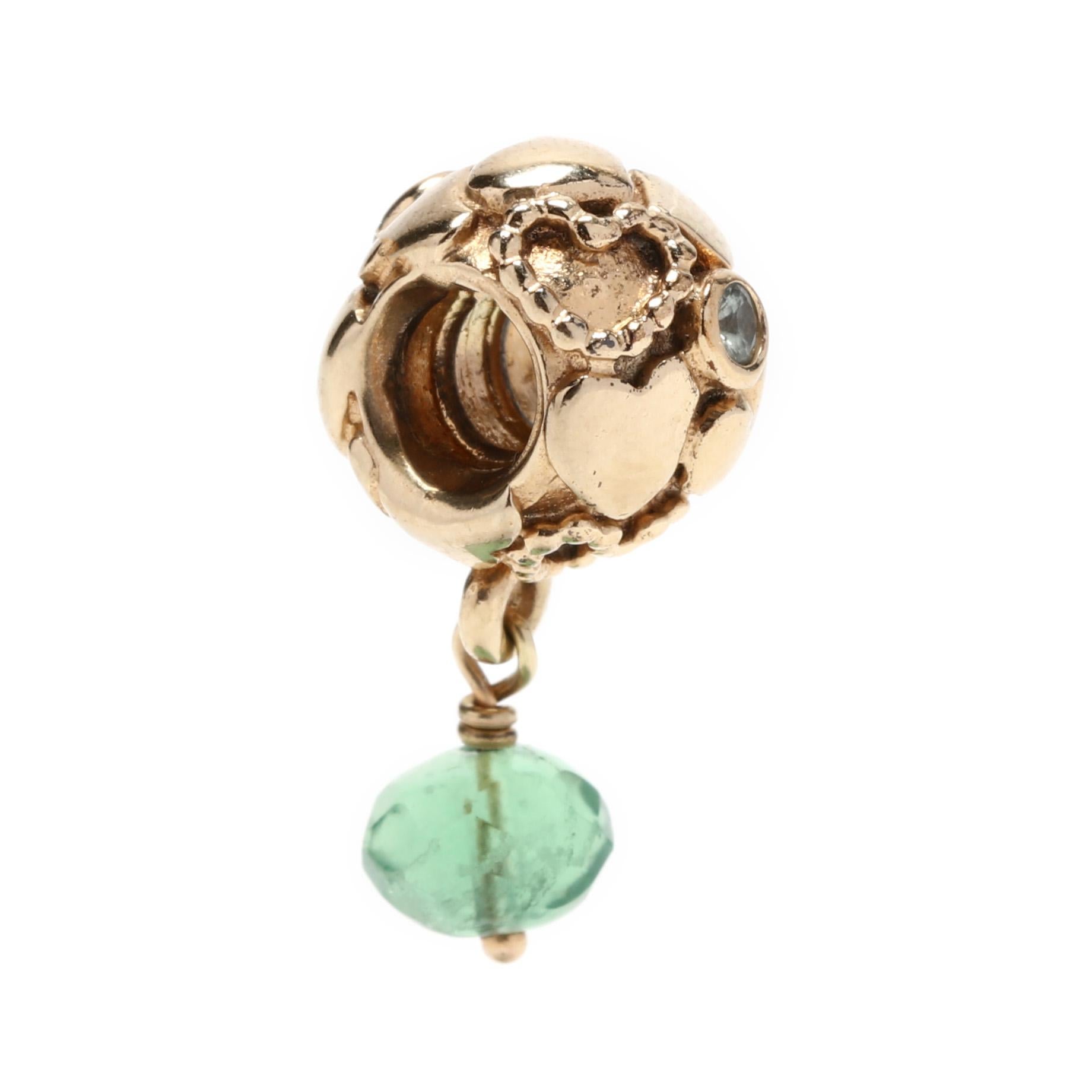 Pandora 14 karat yellow gold green stone dangle heart nugget charm. This charm features a round screw on ball charm with overlapping heart motifs, two bezel set round stones and a faceted green stone dangle.

Length: 1.75 in.

Width: 5/16 in.

3.3