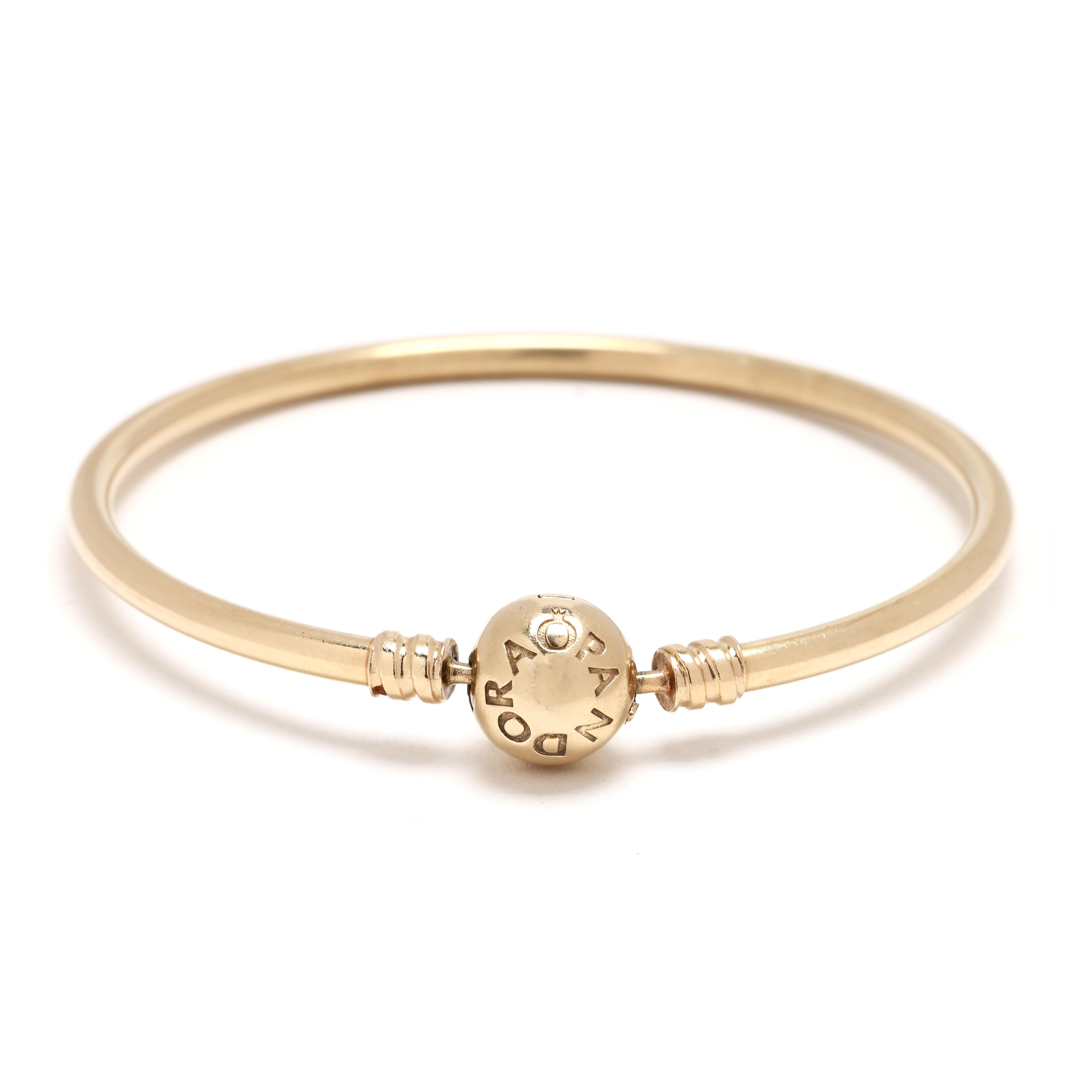 Indulge in timeless luxury with this authentic PANDORA ALE bangle bracelet, crafted in radiant 14k yellow gold. Measuring 7 inches in circumference, this elegant bracelet features a sleek, minimalist design that’s perfect for layering or wearing