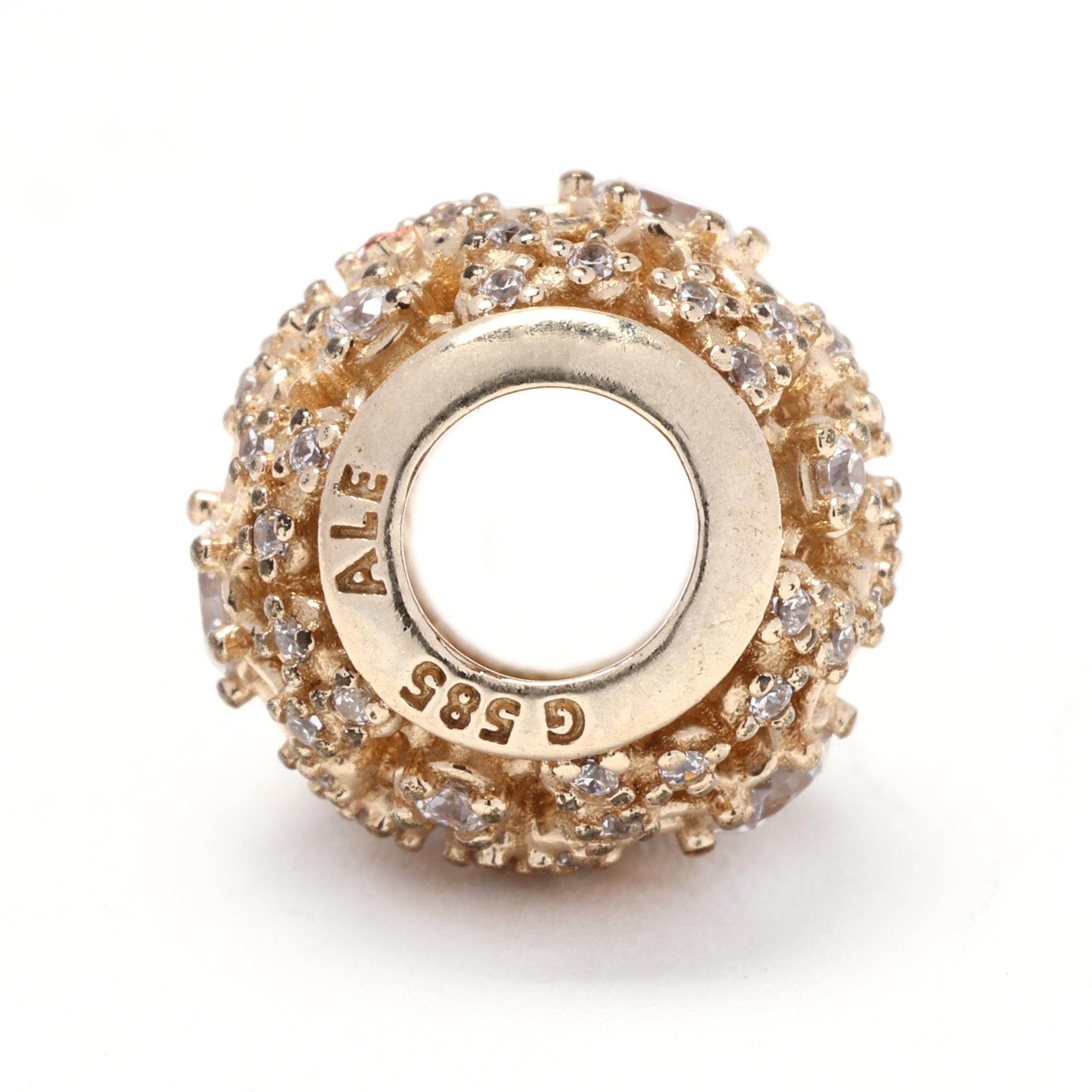 This gorgeous Pandora CZ Gold Charm is a stunning addition to your Pandora bracelet. It features a 14k yellow gold outer ring with a radiant CZ (cubic zirconia) center stone. The Inner Radiance charm is the perfect way to add a touch of elegance and
