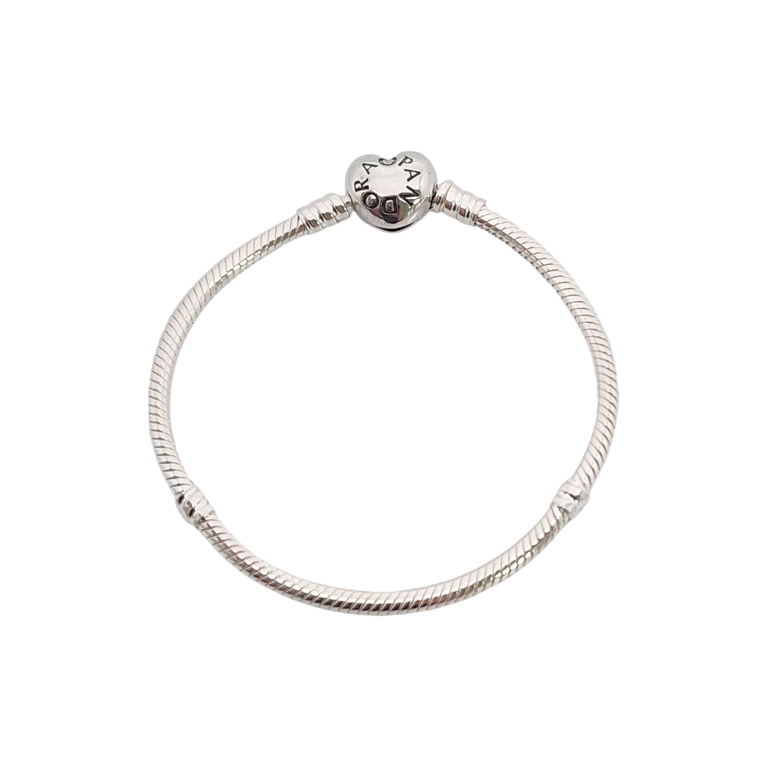 Authentic Pandora Moments Sterling Silver Heart Clasp Snake Chain Bracelet with box.

#590719-17

Pandora's iconic snake chain bracelet featuring a heart clasp  featuring Pandora on one side, Crown O monogram on the other. Includes original plastic