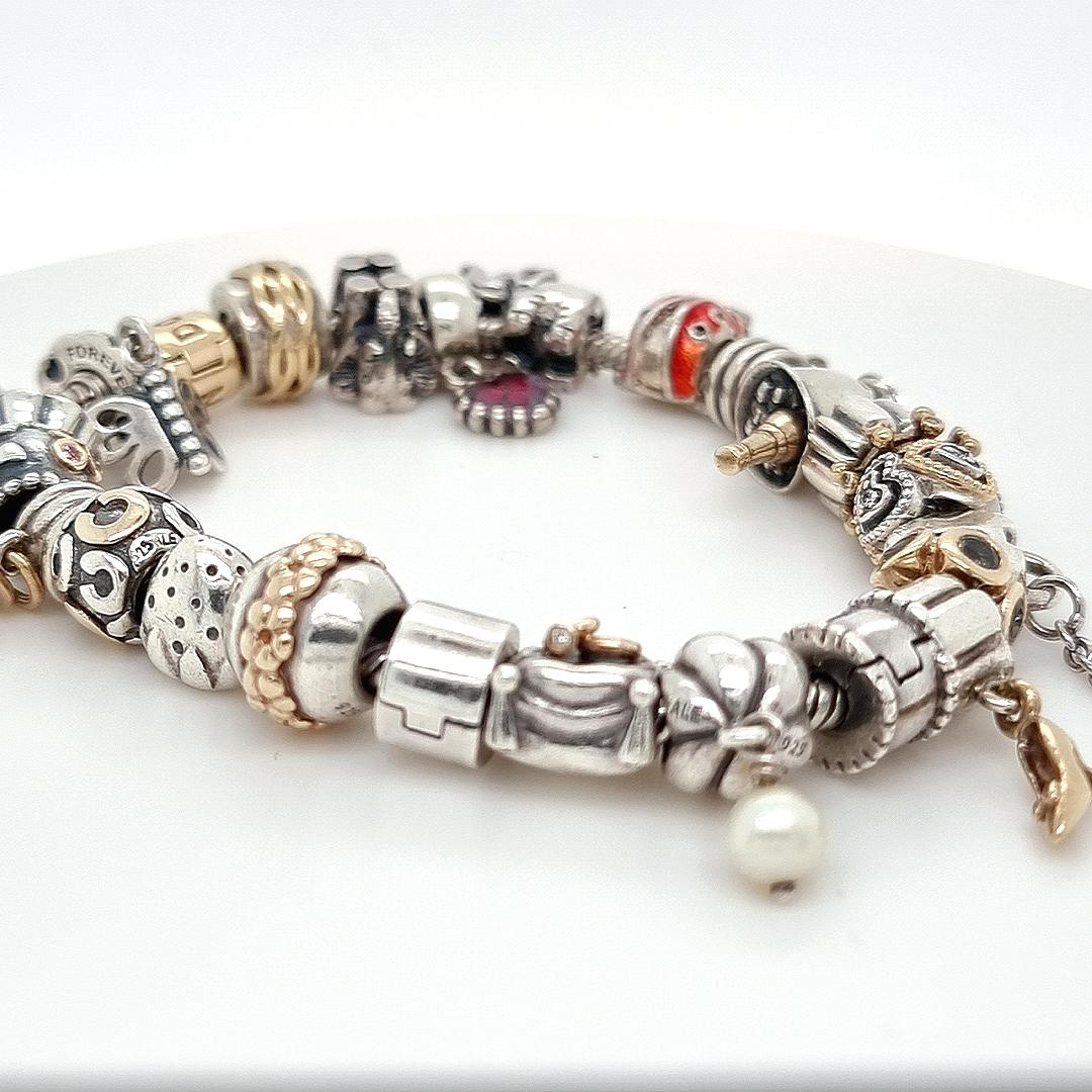 Unique features: 

Pandora Silver Charm Bracelet

Metal: Silver

Carat: N/A

Colour: N/A

Clarity:  N/A

Cut: N/A 

Weight: N/A

Engravings/Markings: N/A

Size/Measurement: N/A

Current Condition: Excellent - Consistent with age and use.