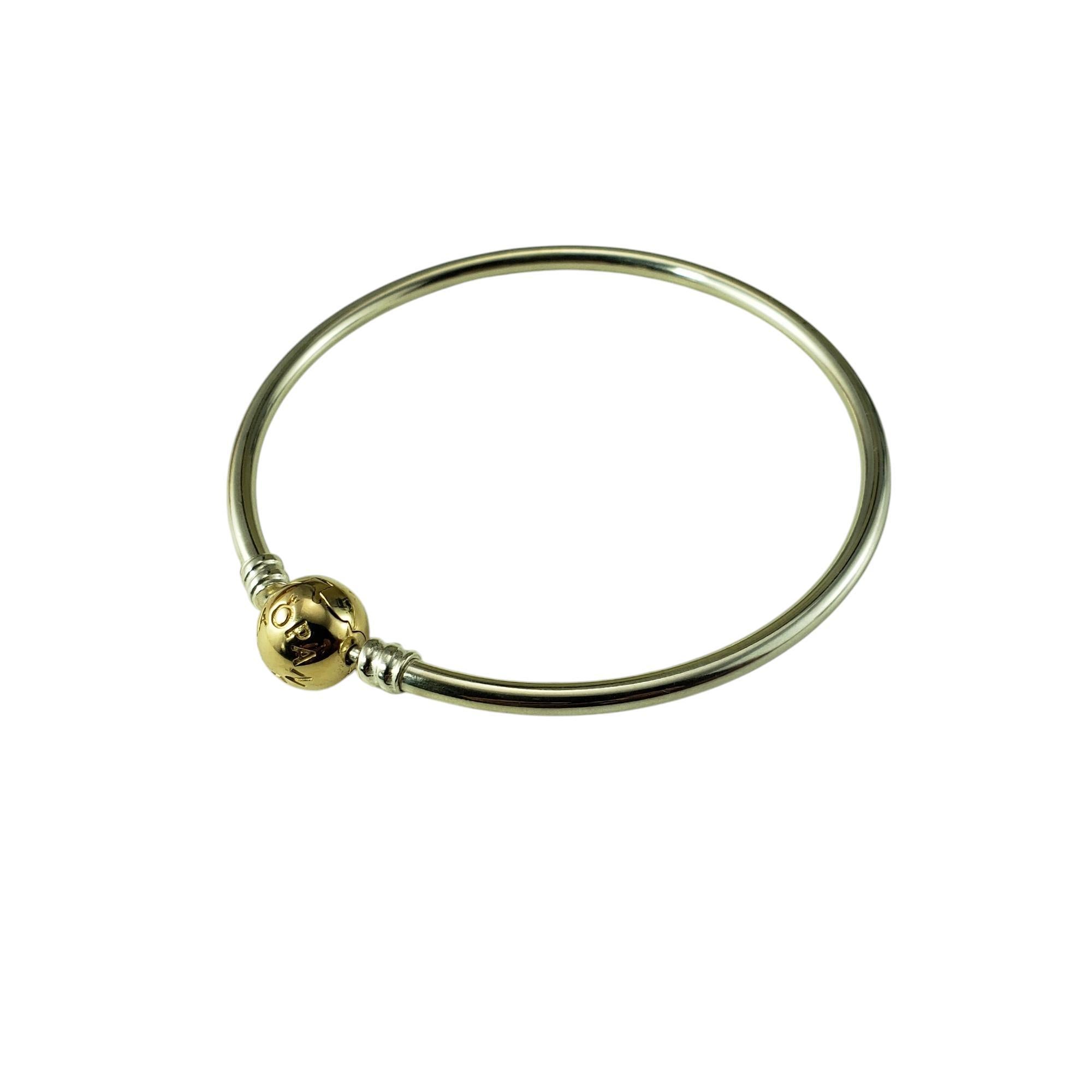 Pandora Sterling Silver and 14K Yellow Gold Moments Bangle Bracelet-

This elegant Pandora bangle bracelet is crafted in polished sterling silver and is finished with a 14K yellow gold signature ball clasp. 

Width: 3 mm.

Size: 7.5 inches

Weight: