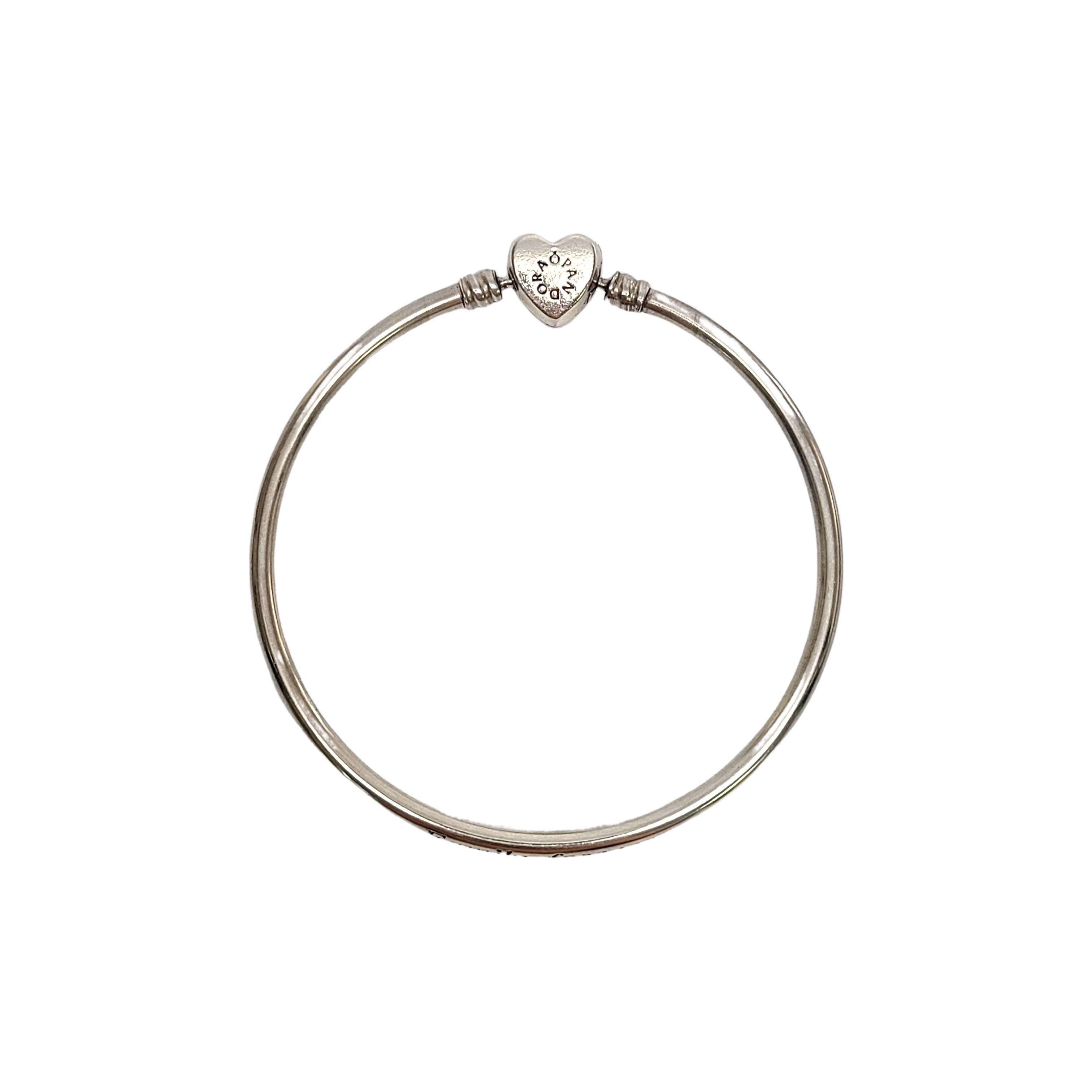 Pandora Wishful Heart Family Forever sterling silver bangle bracelet with CZ heart closure.

#590729CZ

This lovely Pandora bangle bracelet features a CZ heart clasp. 