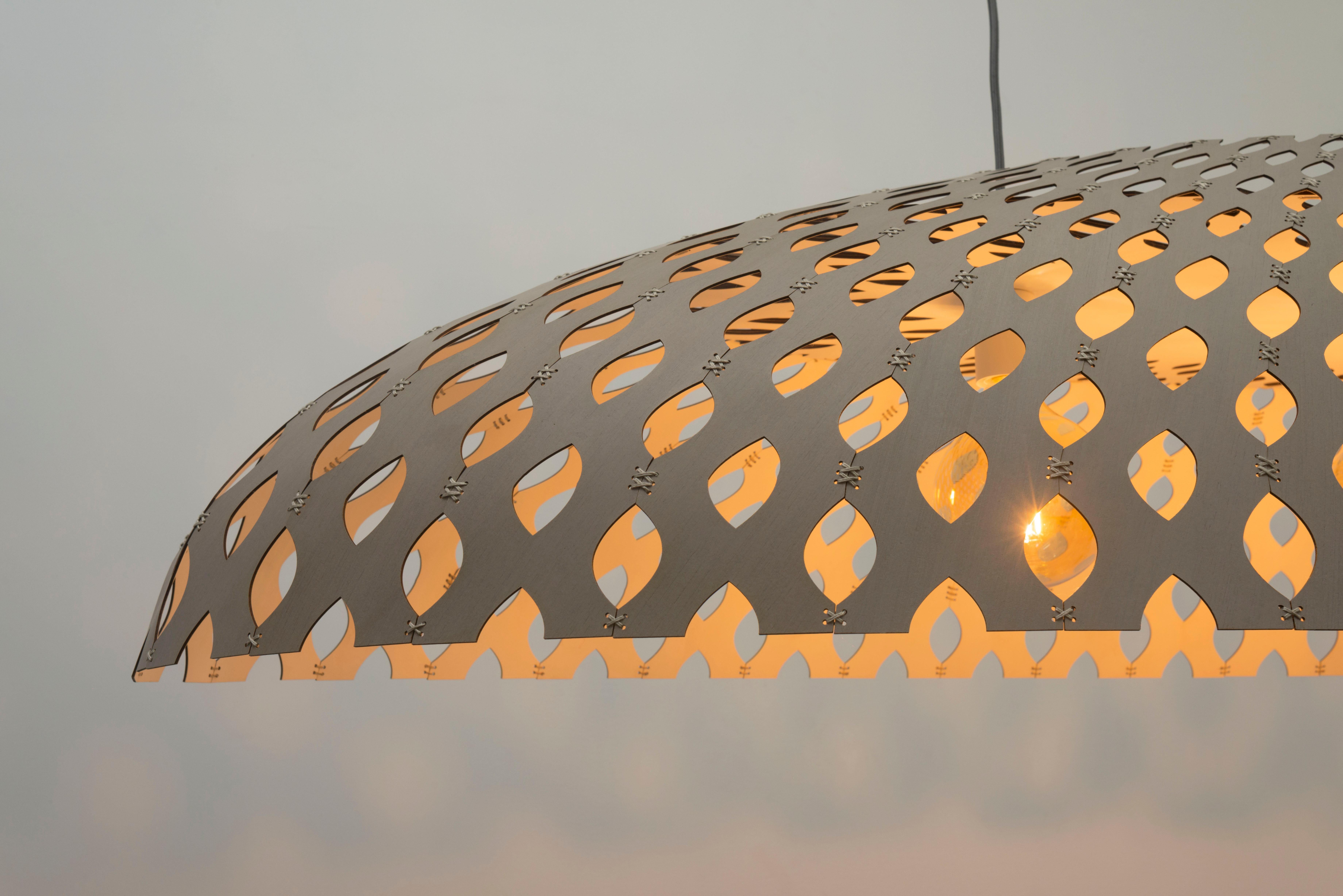 The elliptical bamboo ceiling lamp is a stunning centerpiece that brings a touch of nature to your home. Its elongated shape creates a sleek, modern silhouette, while the natural bamboo material adds warmth and texture. This lamp is designed to