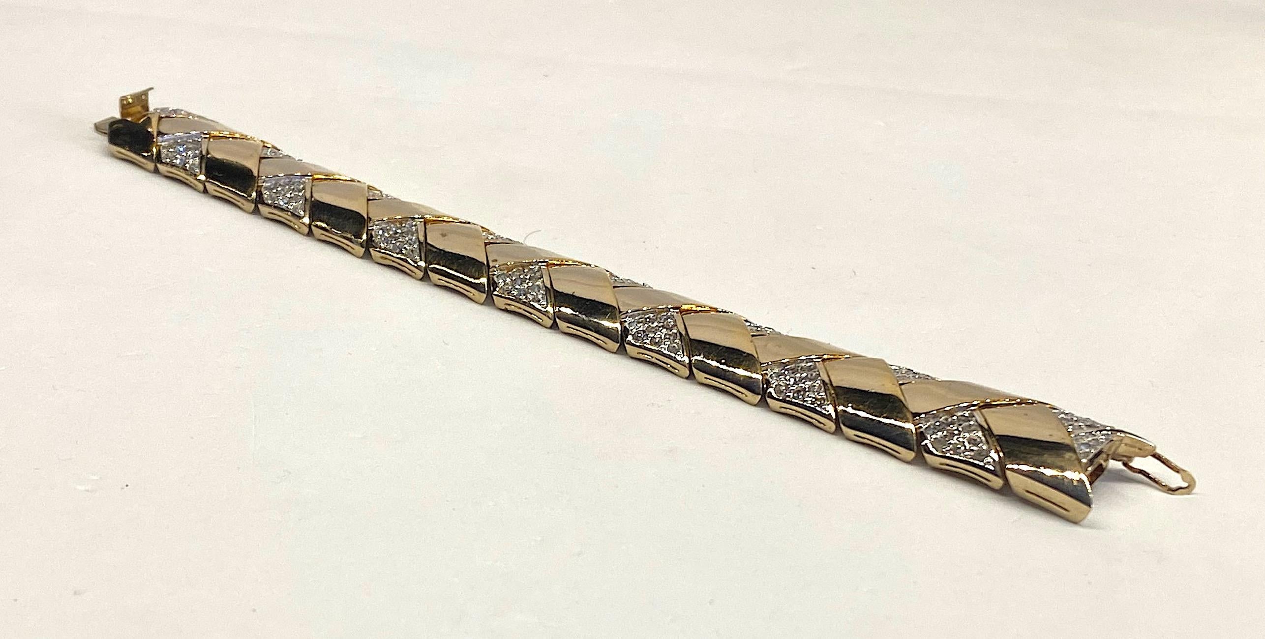 Beautifully made with a zig zag link design is this late 1970s to early 1980s Panetta bracelet. The The links are V shape in gold plate with on side in pave' rhinestone. Assembled as the bracelet the V shape links create a zig zag design. The