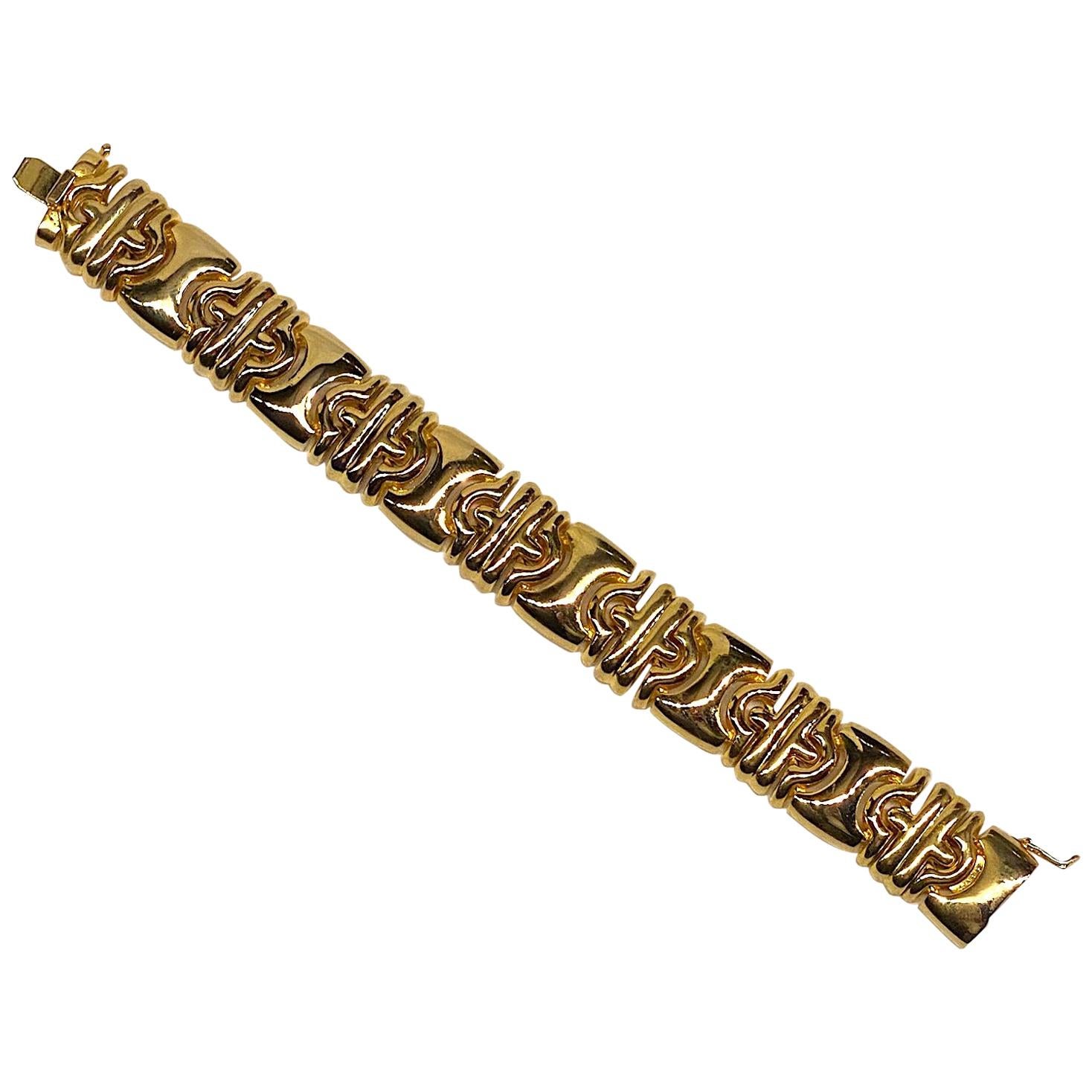 A lovely tailored Parentesi style link bracelet from the 1980s by American fashion jewelry company Panetta. The bracelet measures .75 of an inch wide and 7.75 inches long with a wearable length of 7.5 inches. Shiny gold plate top and a textures gold