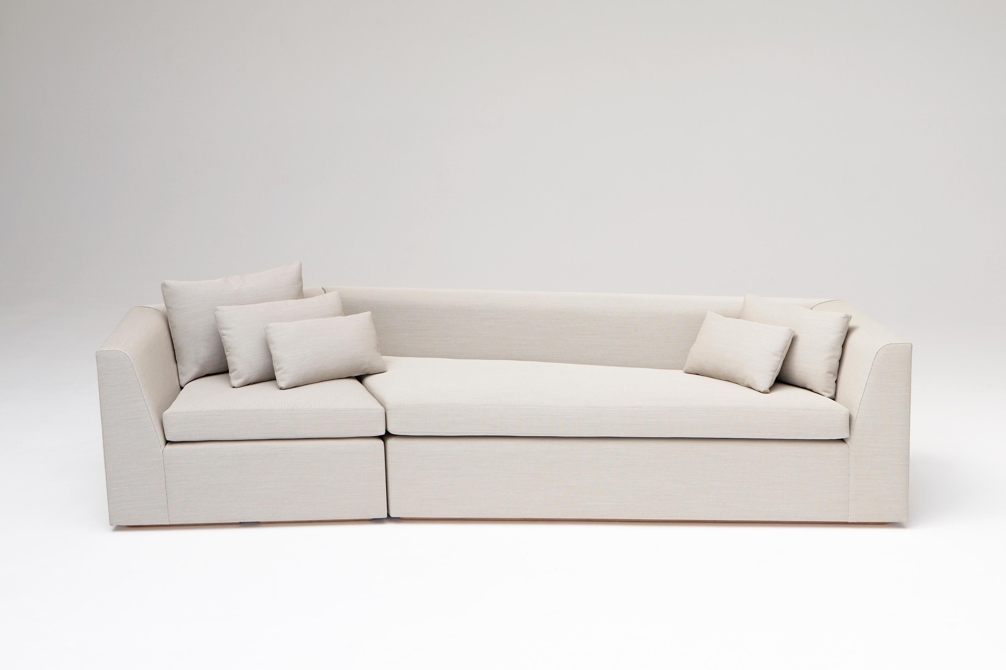 Pangaea Sofa by Phase Design
Dimensions: D 99.1 x W 274.3 x H 63.5 cm. 
Materials: Birch wood and upholstery. 

Hardwood construction with upholstered body and birch base. Upholstery may be sourced in the Customer's Own Material (COM), the