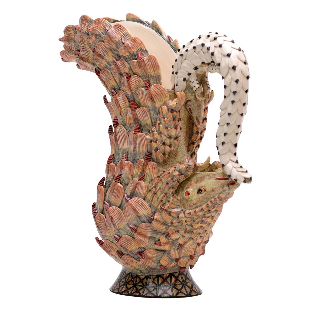 This extraordinary Pangolin Sculpture is a rare, one-of-a-kind ceramic piece, masterfully sculpted by Motsaman and intricately hand-painted by Jabu Nene of Love Art Ceramics in South Africa. Revered as one of Africa’s most unique and endangered