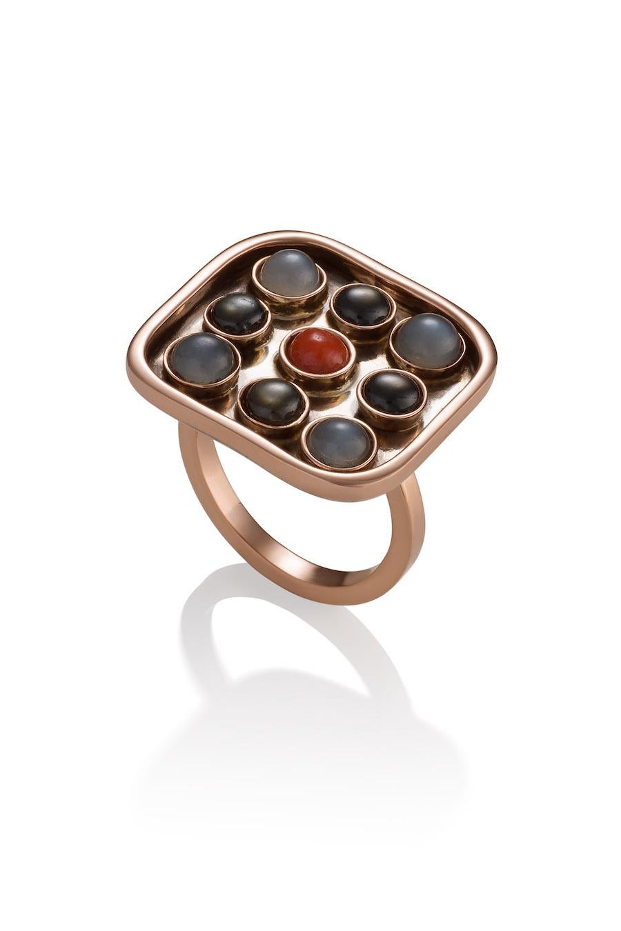14K/10K, Sterling Silver, Black Star Sapphires, Gray Moonstones, and repurposed vintage Coral cabochon set in 14K Rose gold bezels on an oxidized silver platform surrounded by a 10K Rose gold band resting on a  2.5mm wide 10K Rose gold band.
This