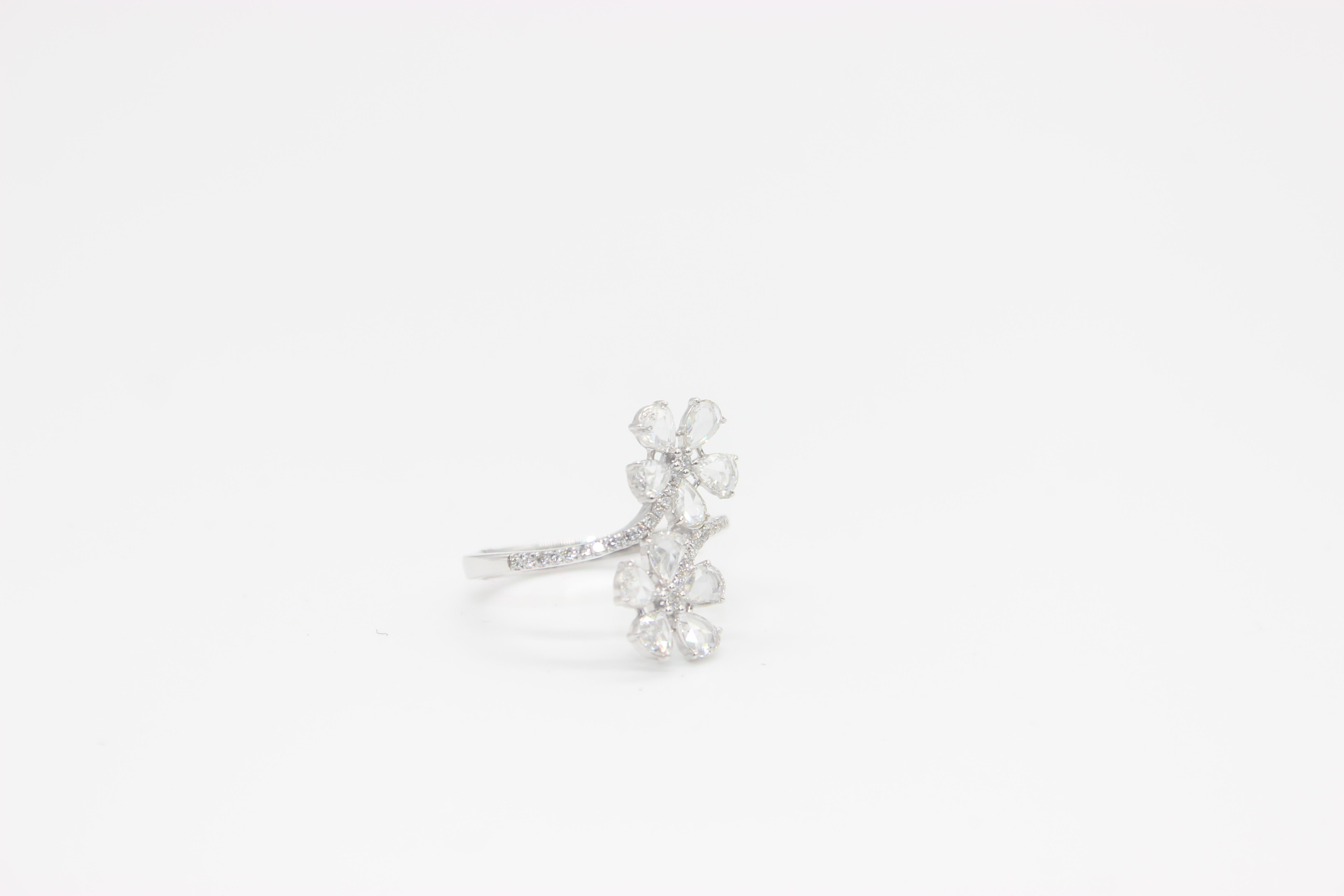 PANIM 1 Carat Diamond Rosecut Floral 18K White Gold Ring

A lovely 18k Panim white gold floral ring. A round brilliant stone with a bright, even tone is put in the middle of the ring. The round brilliant is surrounded by pear-shaped rose cut