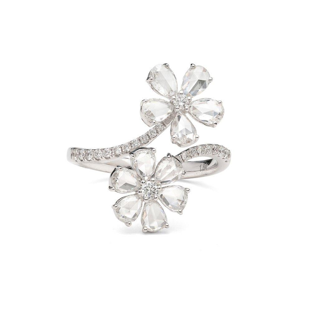 0.96 Carats of Diamond Rosecut and Round  set in Ring made in 18k White Gold

Delicate yet bold, this 18k white gold by-pass ring is charming and unique. Designed with two flowers, featuring pear-shaped rose-cut diamond petals, and