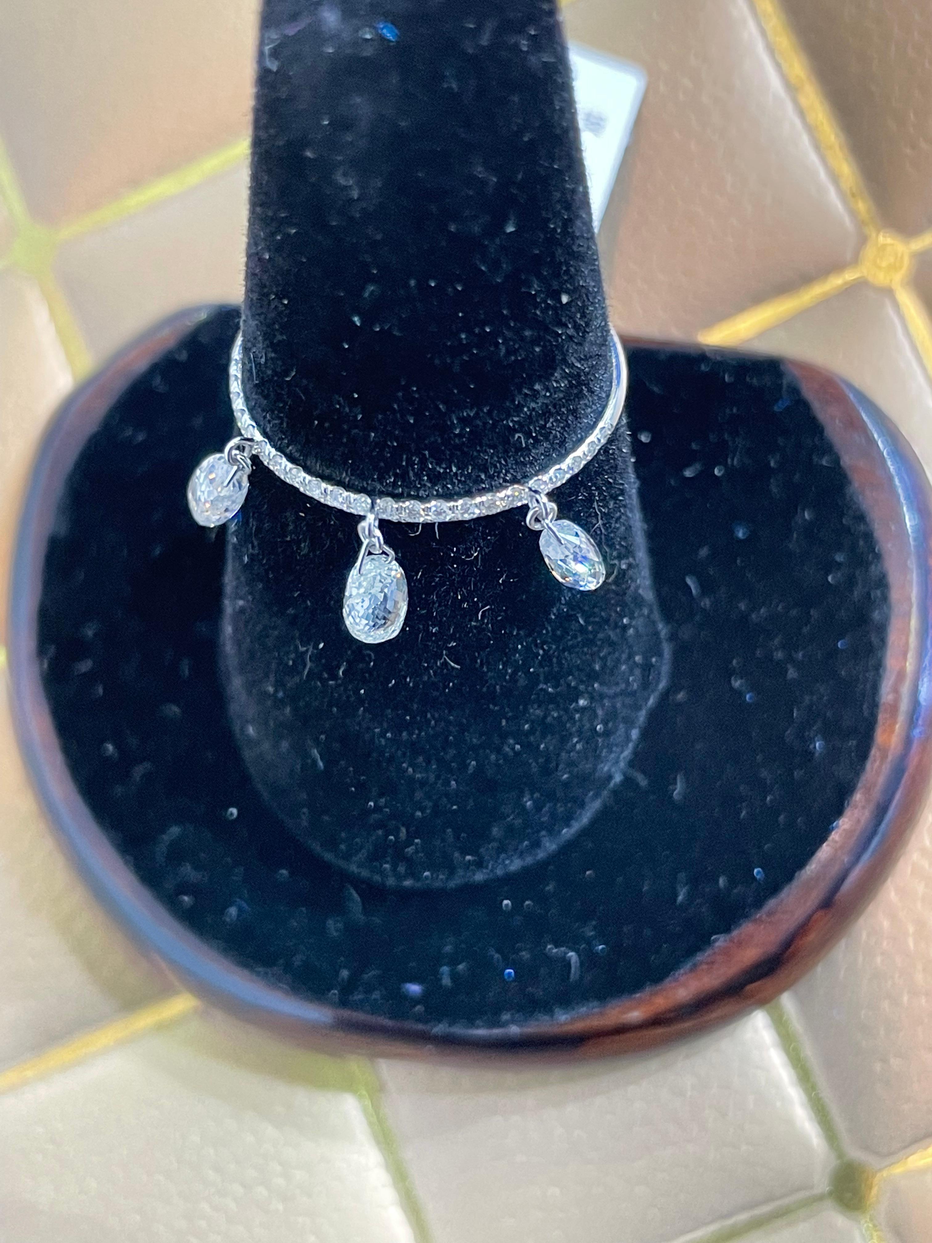 PANIM Briolette Diamond 18K White Gold Dangling Ring

Inspired by the beauty of a rain drop, Our Briolette Dangling diamond ring is an absolute show-stopper.
It has 3 piece of Rain Drops White Diamond Briolettes with diamond band having smaller