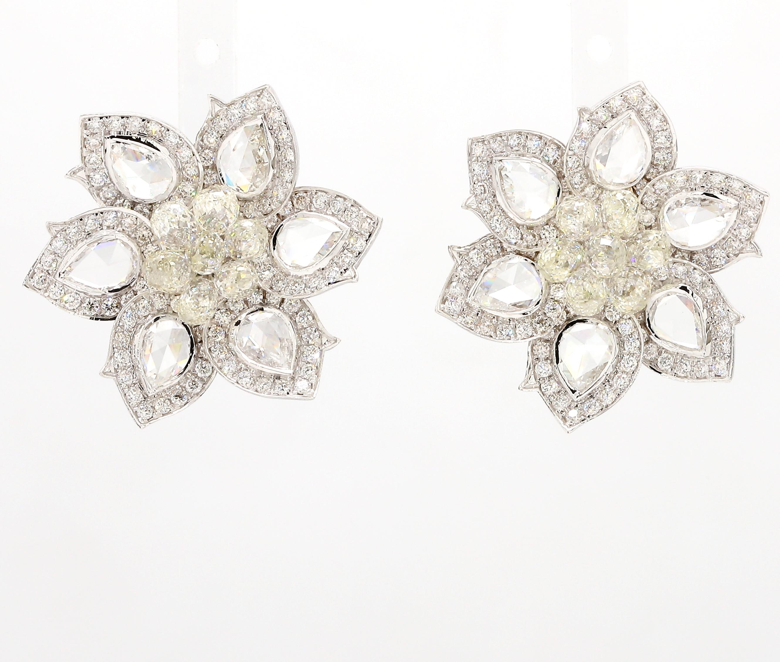 A beautiful rendition of the narcissus flower, the petals features six Pear Shape Diamond Rosecut ,centered with diamond Briolette as a cluster. The earrings are finely handcrafted in 18K White Gold.
These make a fine pair for casual afternoon lunch