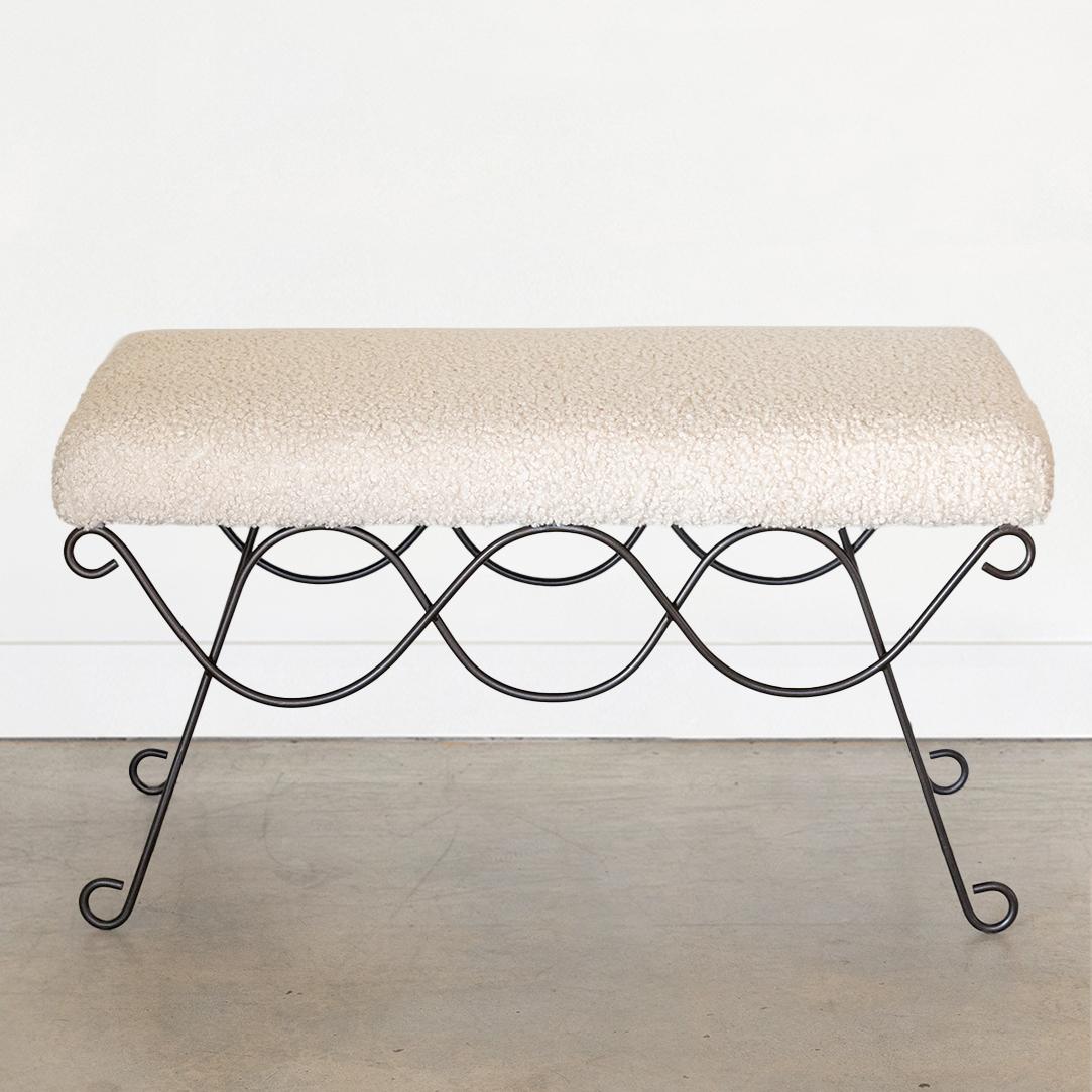 Beautiful iron bench with curved and looped base painted in a matte black finish inspired by French design. Rectangular cushioned seat upholstered in a creamy poodle fabric or can be COM. Multiple available, sold individually. Made in Los Angeles. 