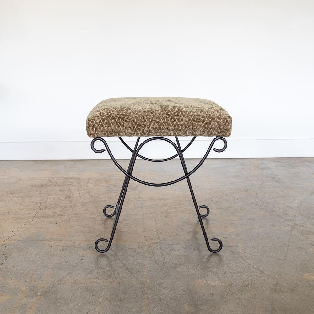 Beautiful iron stool with curved and looped base painted in a matte black finish inspired by French design. Rectangular cushioned seat upholstered in a sage chenille or can be COM. Made in Los Angeles.