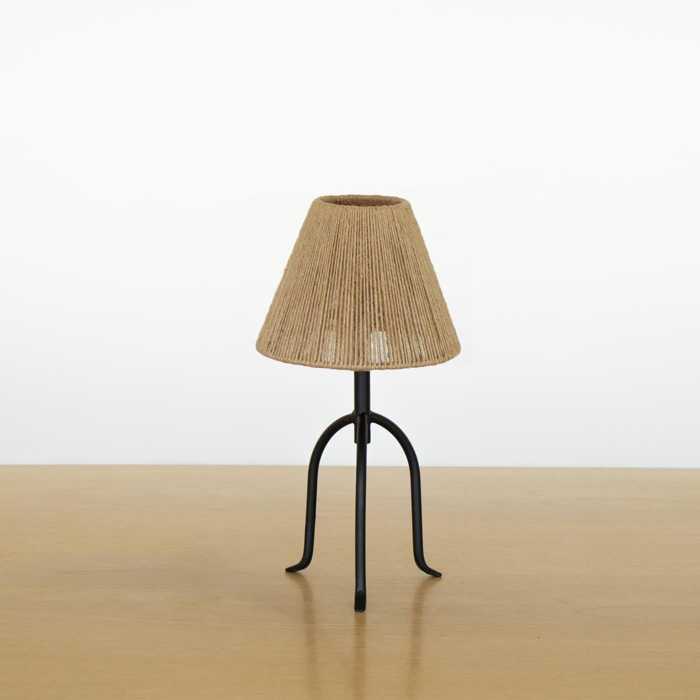 Petite iron tripod lamp with slender legs and tapered feet. New wiring and new rope linen shade. Multiple available, sold individually. Takes one E12 base bulb, up to 25 W or higher using LED.