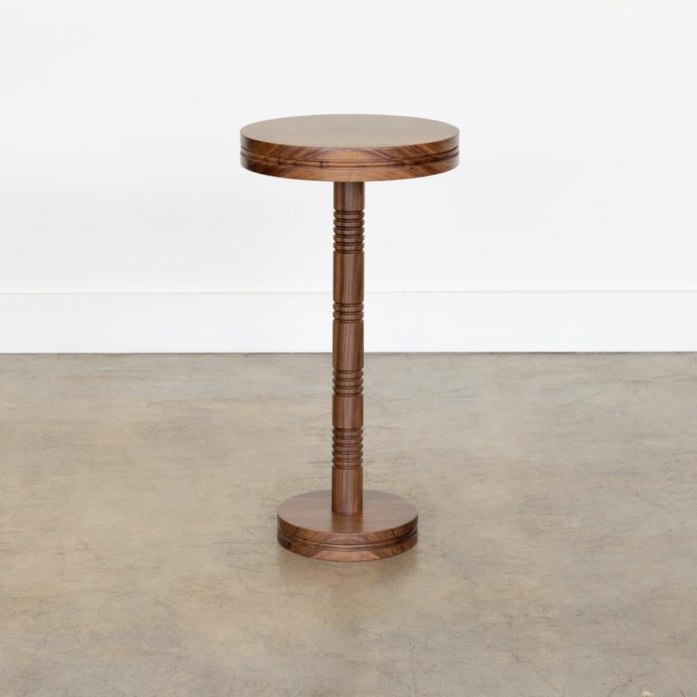 Newly made solid walnut drink table with carved ribbed detailing on stem. Circular top and circular base. Made in Los Angeles. Multiple quantity available.
