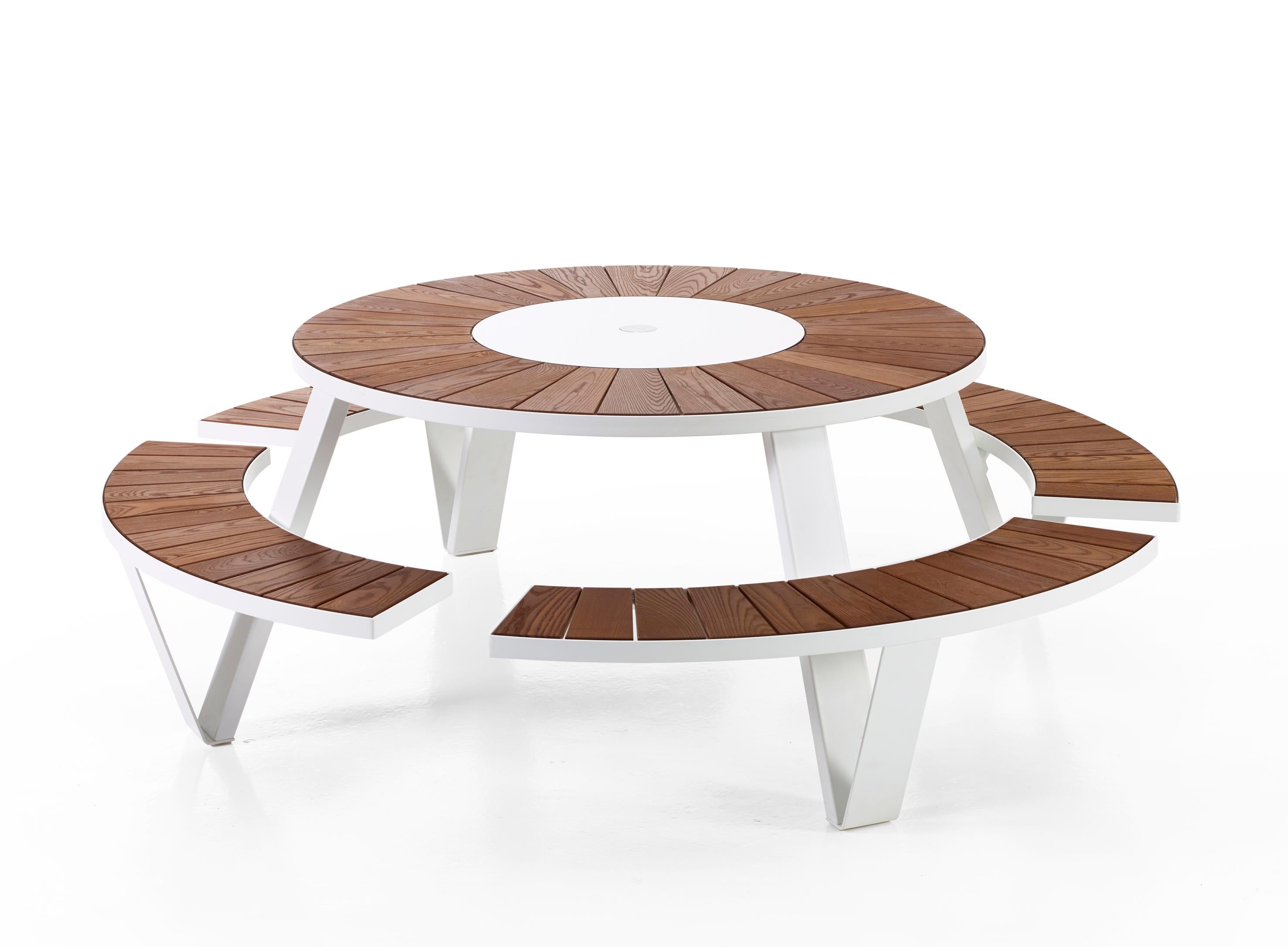 The Pantagruel round picnic table seats eight people comfortably and includes a Lazy Susan. The frame comes powder coated as well as galvanized, tabletop and seats comes in natural Iroko hardwood. Includes Inumbra Parasol that connects to the