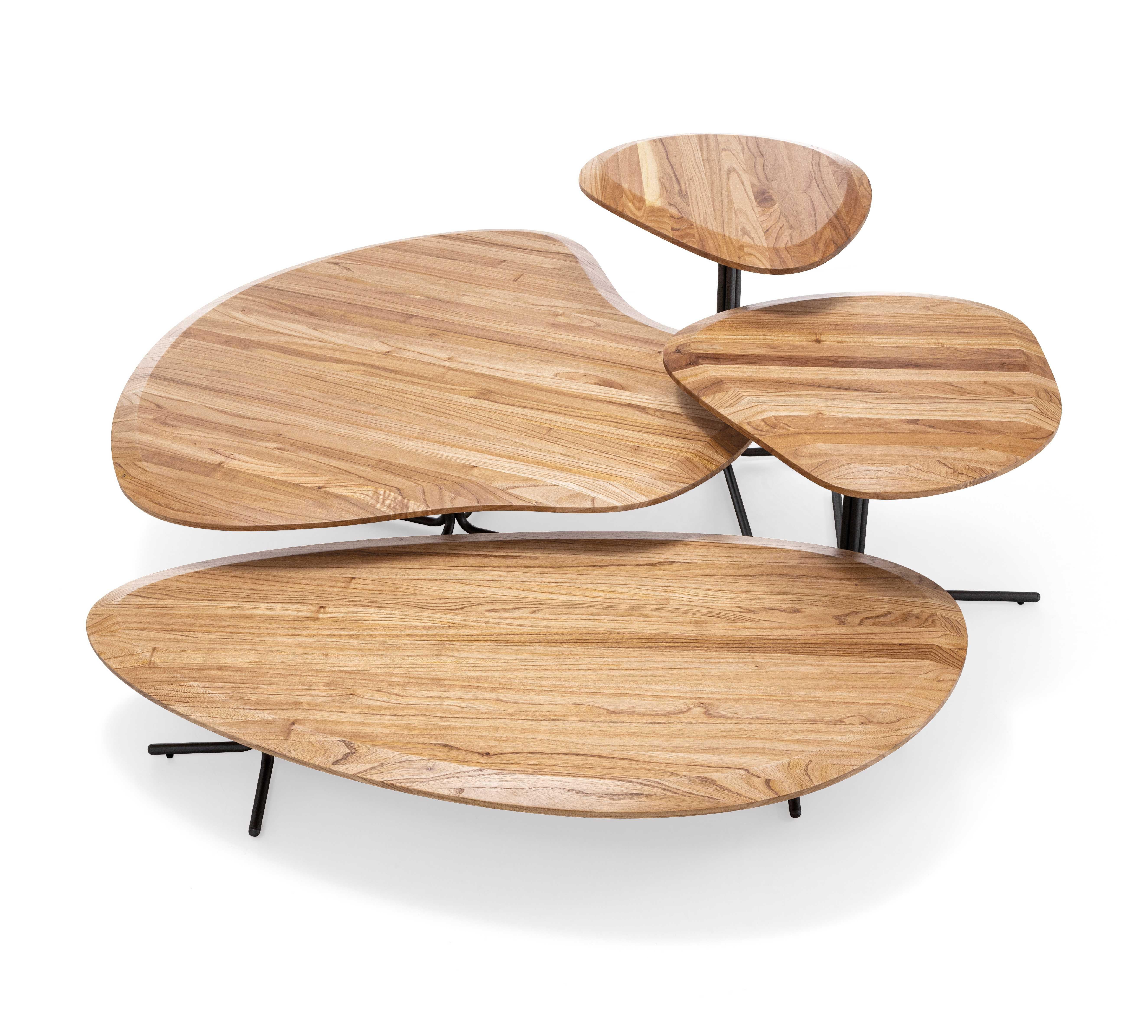 A Pantê coffee table designed by Uultis Studio with 39-Inch teak top and black metal base. The Pantê coffee table combines artistry and practicality, featuring a 39-inch organic-shaped teak wood top supported by a sleek black metal base. Inspired by