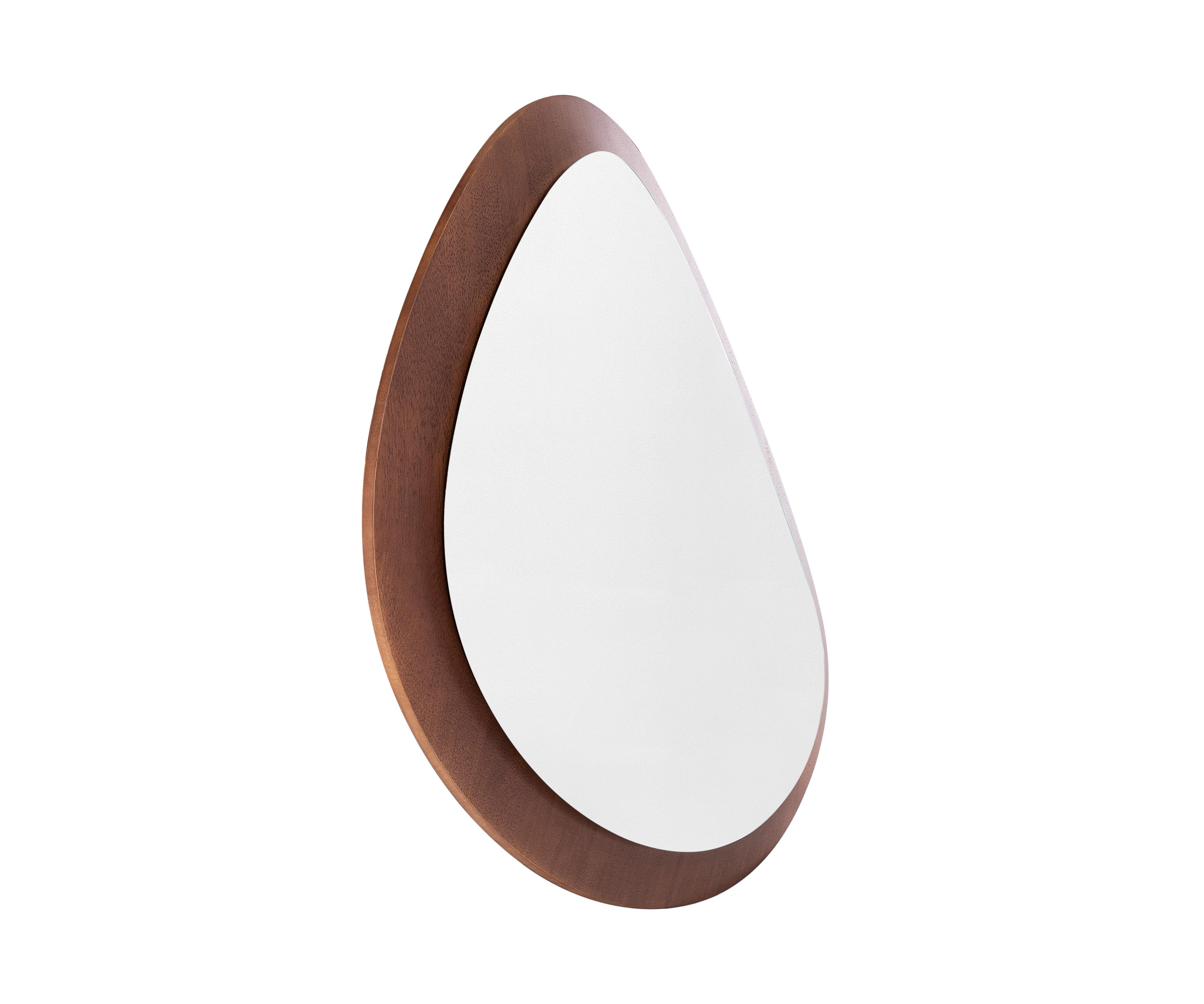 The Pantê series of mirrors, in its walnut variant, is a celebration of organic beauty inspired by the distinctive spots of a jaguar's coat. Each mirror in this smaller model is meticulously crafted with a woodwork frame that not only enhances its
