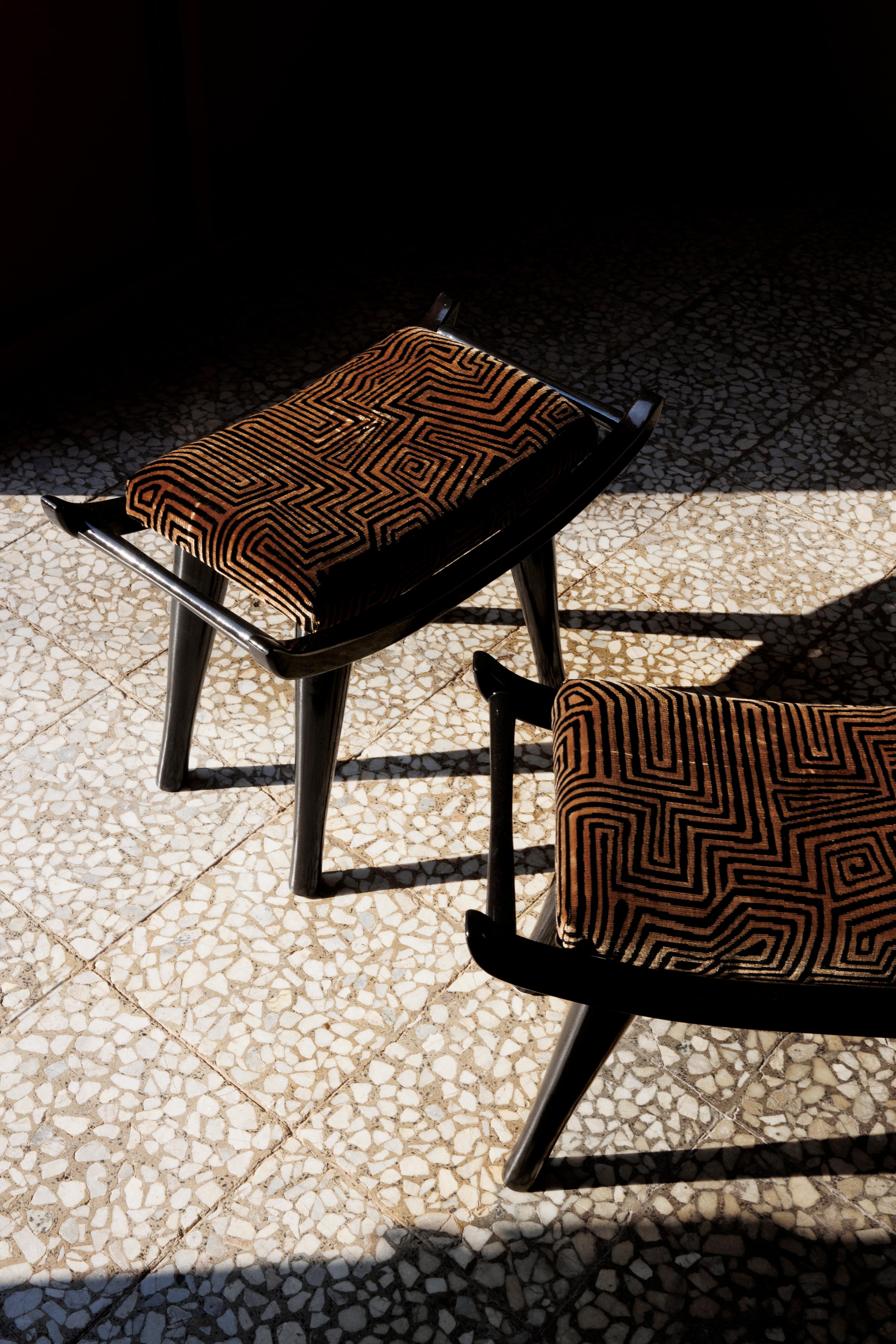 Pantera is a stool that carries its elegance with quiet confidence. Designed with elongated lines and softened geometry it merges comfort with sculptural clarity. The lacquered wood base offers a refined architectural silhouette while the Dedar