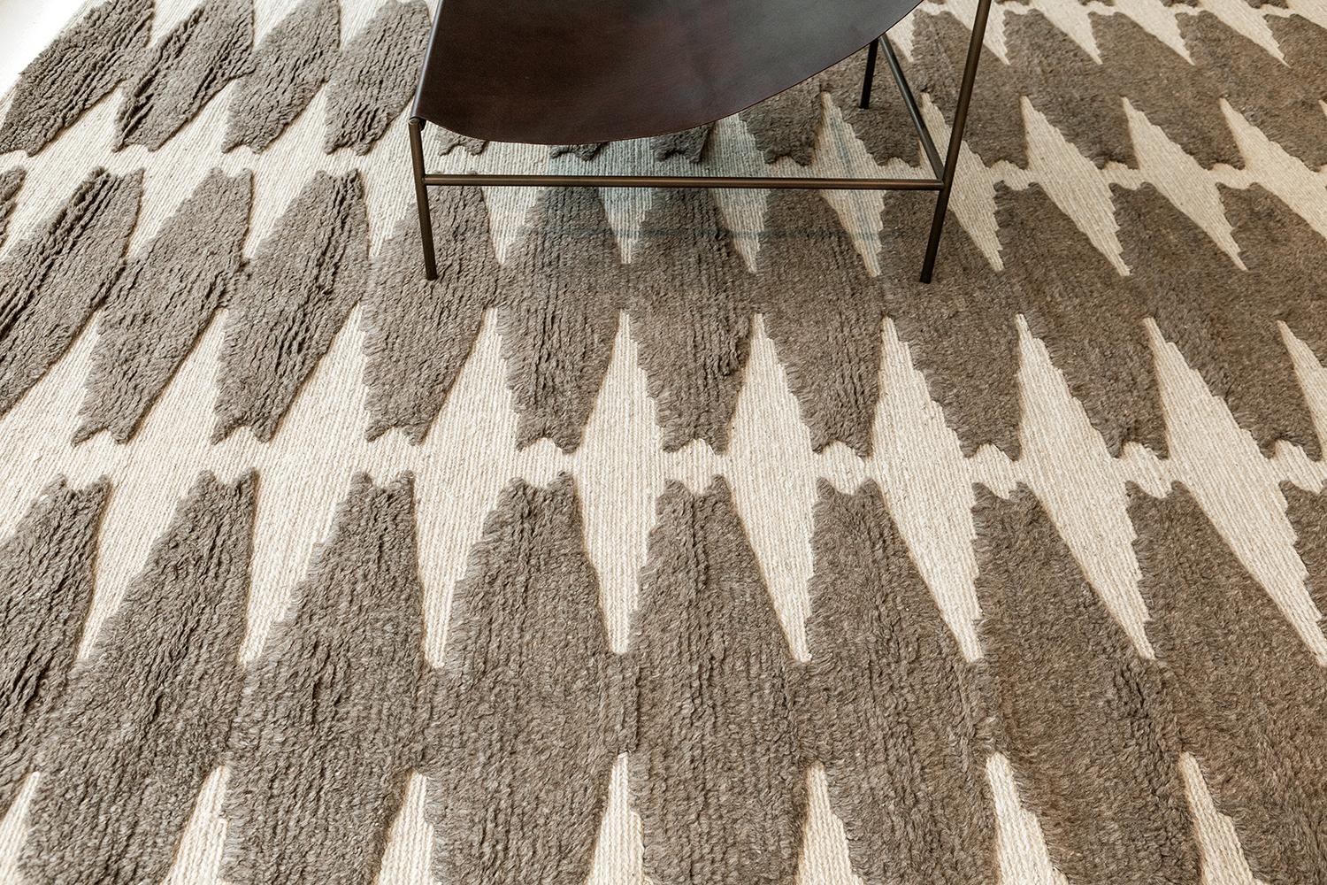 Pantera features an all-over cocoa brown lozenge motif on an ivory field. The textural contrast of embossed pile and flatweave ground delights the foot. Refined design is matched with vivid tonal palettes in the Michael Berman Collection. These are