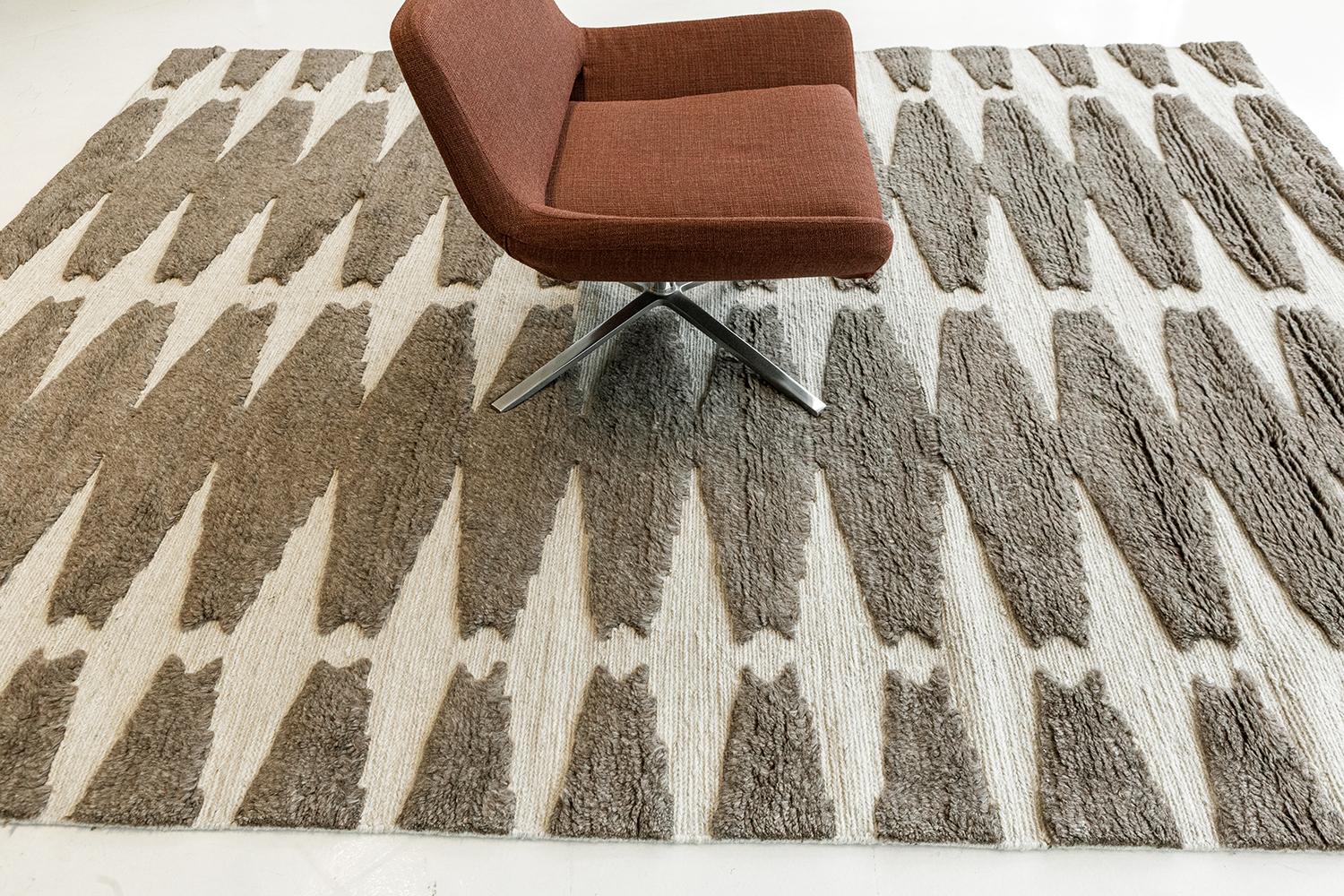 Pantera features an all-over cocoa brown lozenge motif on an ivory field. The textural contrast of embossed pile and flatweave ground delights the foot. Refined design is matched with vivid tonal palettes in the Michael Berman Collection. These are