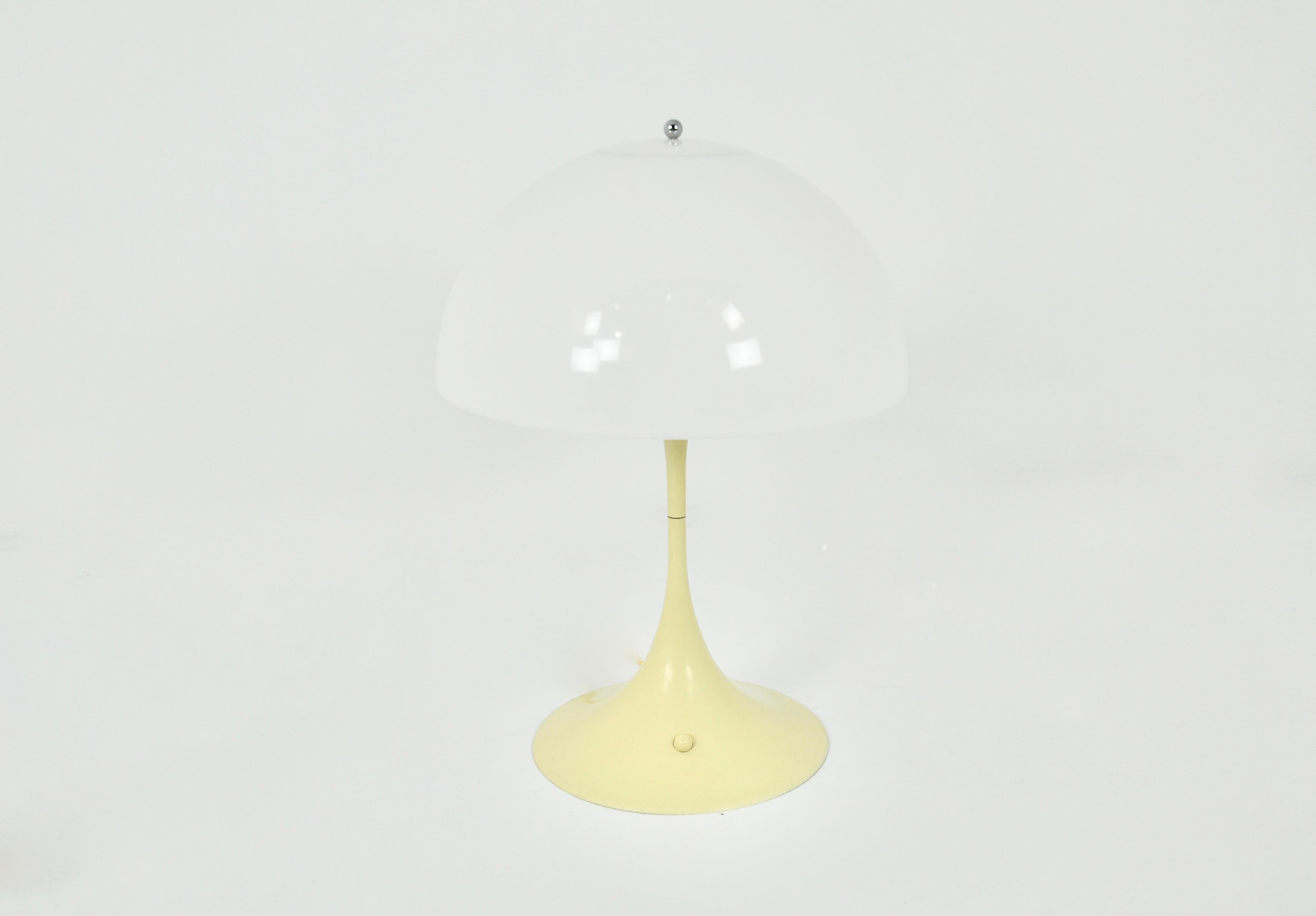 Plastic and metal lamp in creamy white. Stamped under the lamp. Wear due to time and age of the lamp.