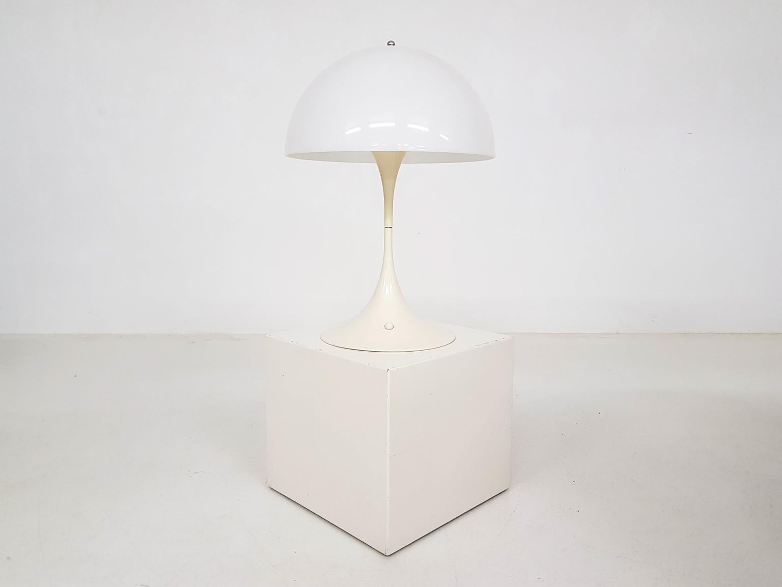 The famous table light by Verner Panton for Louis Poulsen. Designed in 1971.

Panton designed this table light in 1971 as a part of the Panthella collection. The light is still a classic and popular item today. The lamp features a Acryl shade that