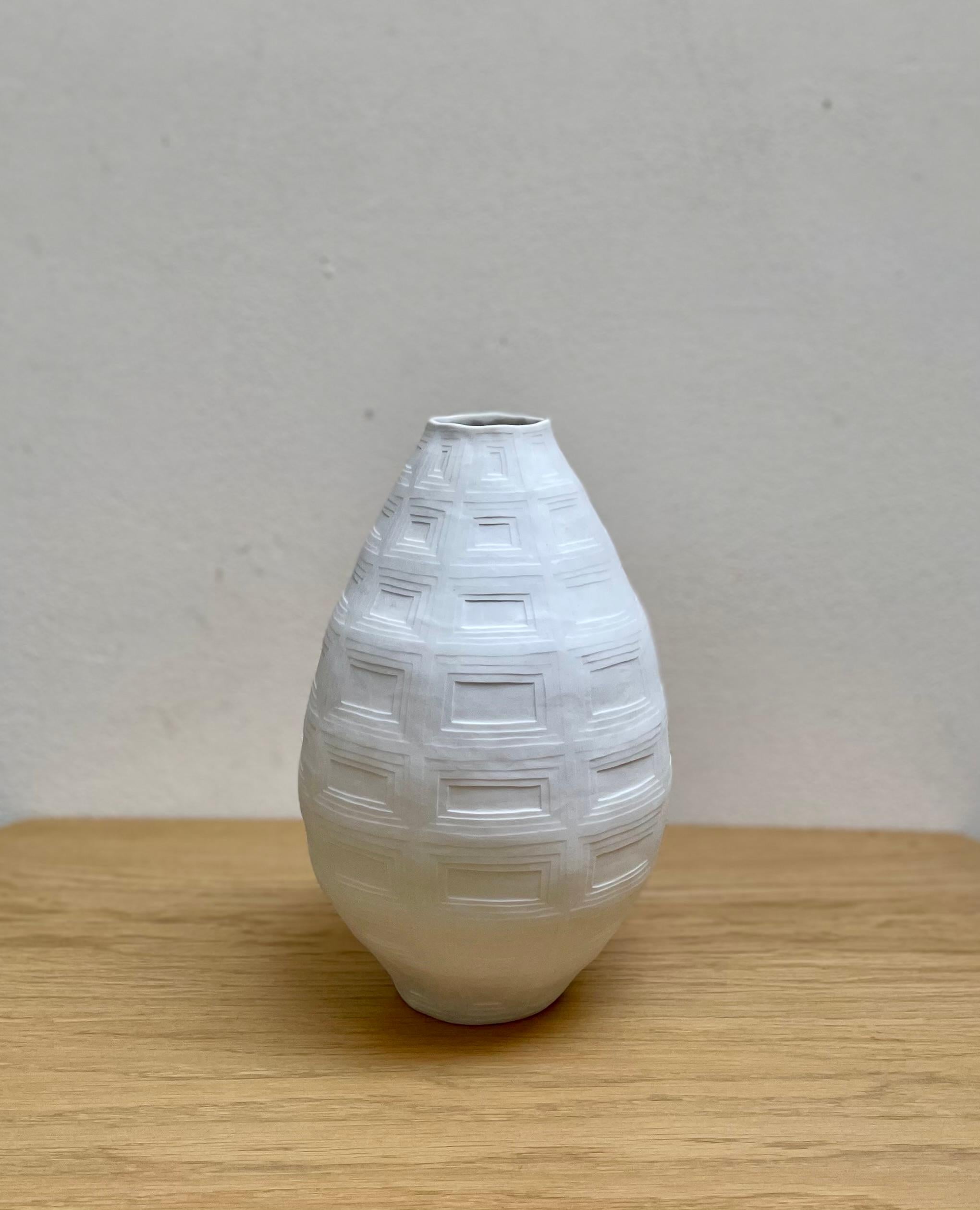 Handmade Porcelain Pantheon Vase – ARCHITECTURE Collection by JHA Porcelain. This unique, handbuilt vase is crafted using the traditional coil technique, giving it a distinctive and timeless look. The exterior of the vase is adorned with a pattern