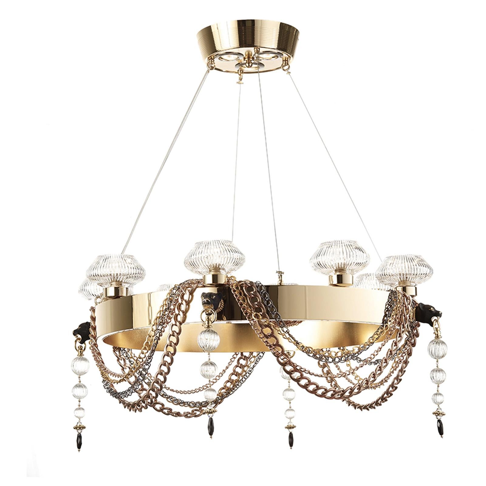 This unique chandelier will add drama and a bold decoration to an entryway or a dining room. A veritable jewel, this object of functional decor features a top hand-brushed brass base with three GU10 x 10W LED bulbs supporting a ring structure also
