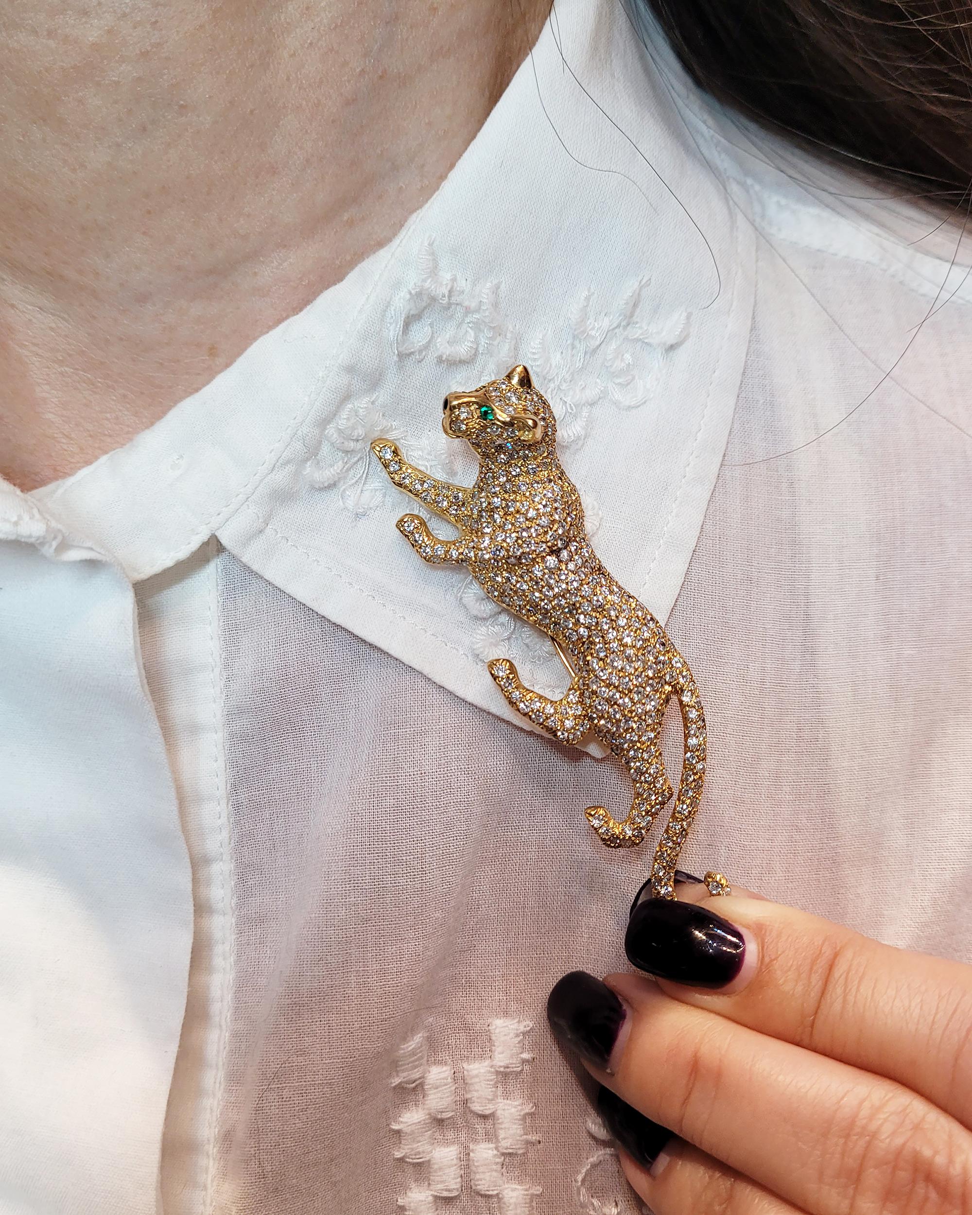 Introducing the 18kt Yellow Gold Panther Pin, a truly captivating and luxurious piece that seamlessly blends the majesty of a panther's form with the brilliance of diamonds and the allure of emeralds. 

Crafted from 18-karat yellow gold, the