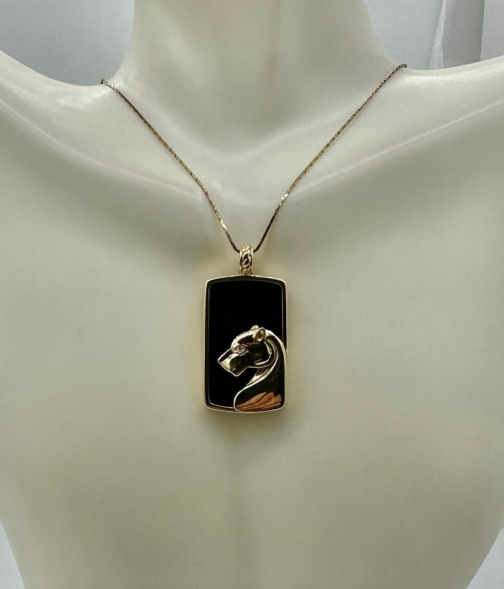 This is a wonderful Diamond and Black Onyx panther, lion, or leopard pendant in 14 Karat Yellow Gold.  The stunning pendant is in the style of the Cartier panther jewels.  The panther has a Diamond eye and is set on a Black Onyx ground.  We love our