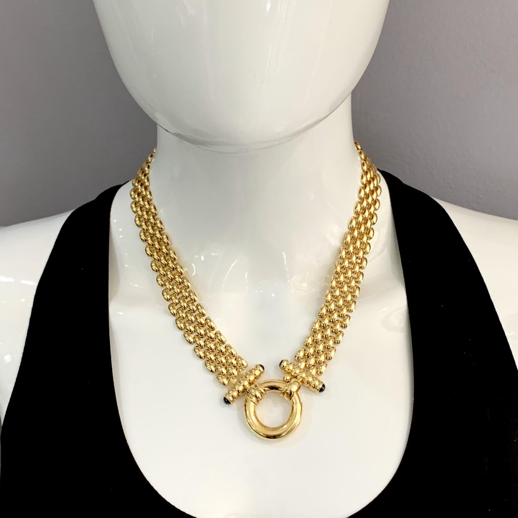 A beautifully made cornerstone piece in 14 karat yellow gold, this fabulous five-row panther chain has bar ends tipped with onyx cabochons and an oversized bolt ring closure that can be worn front or back:  as versatile as it is