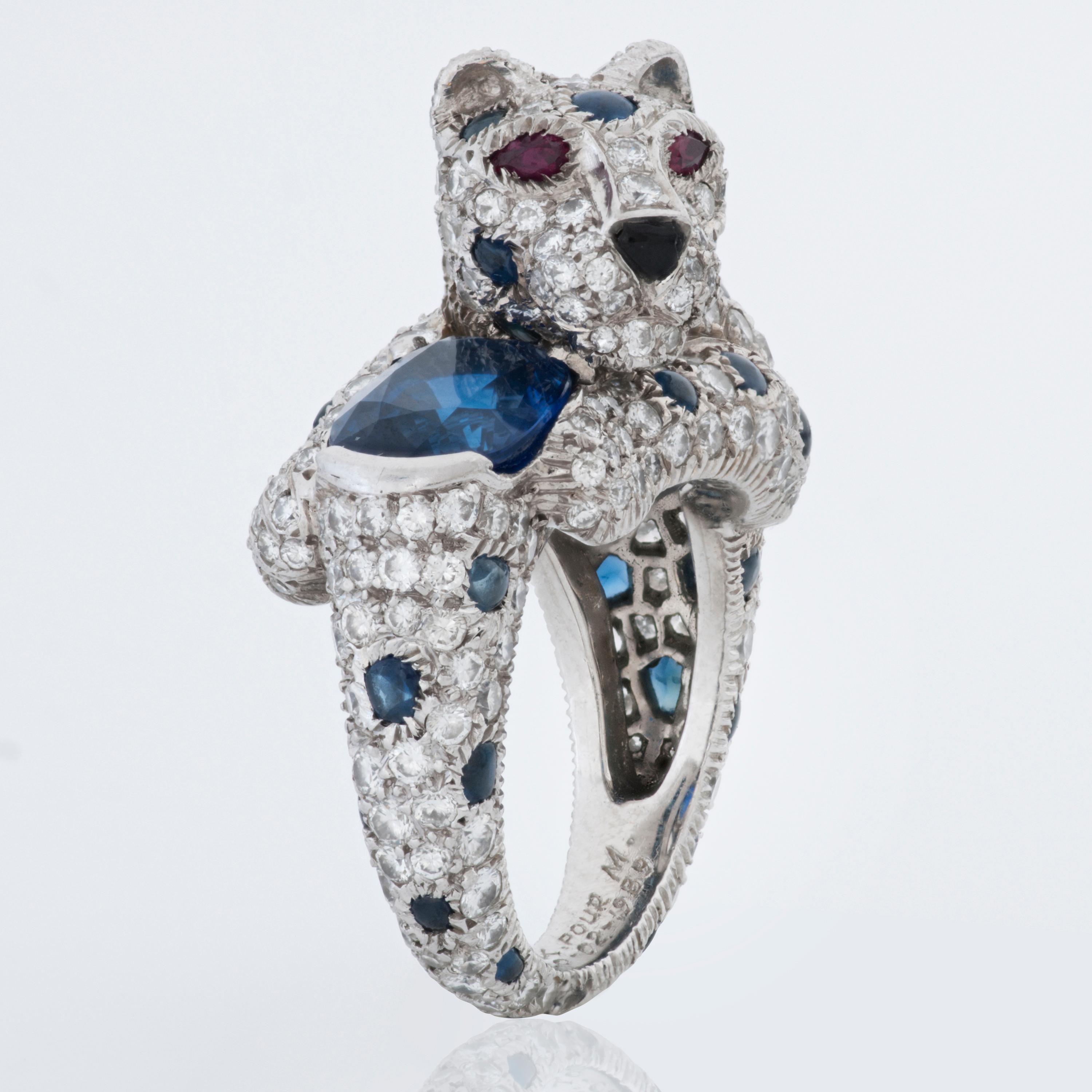 The centerpiece of this Panthere De Cartier ring is a 2.90 carat oval blue sapphire.  It features an additional 42 round cabochon sapphires totaling approximately 2.50 carats, as well as approximately 3.90 carats of round brilliant cut diamonds