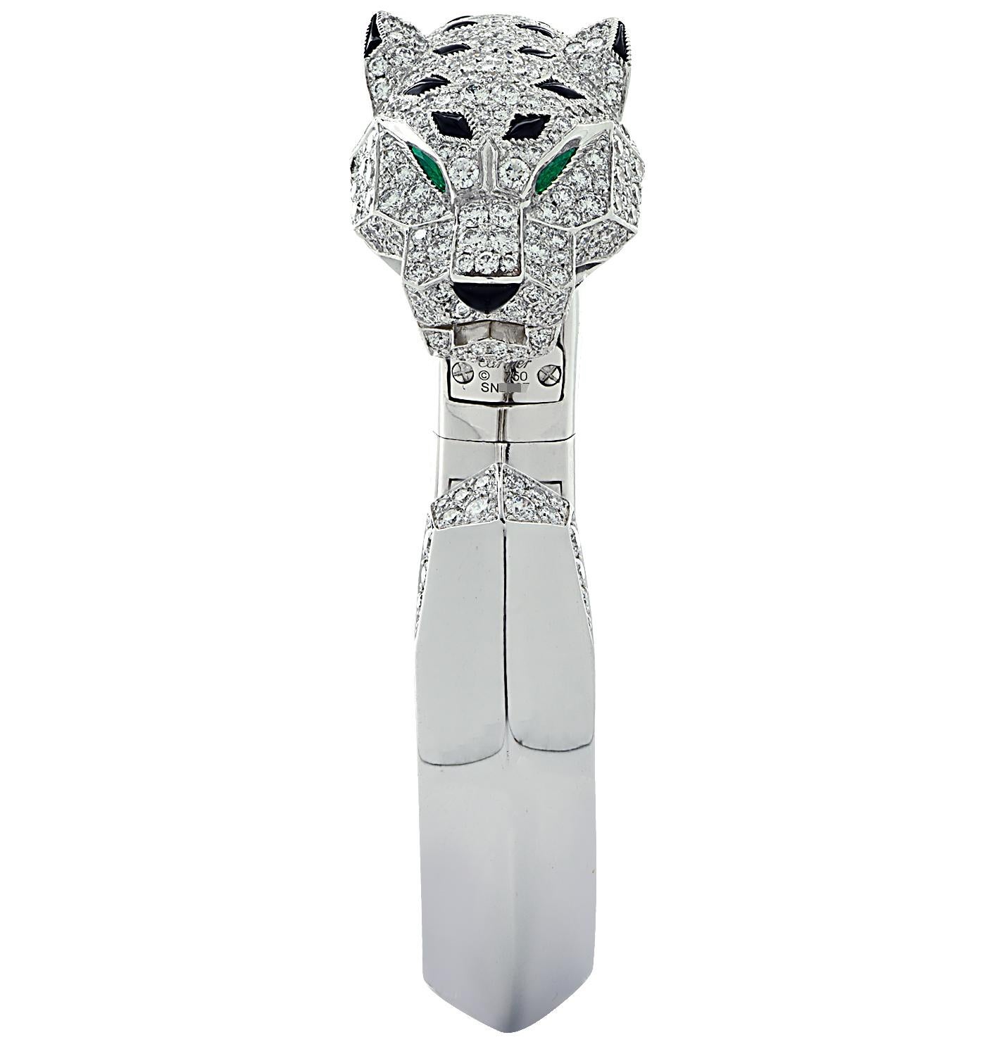 Sensational Panthere De Cartier Bracelet crafted in 18 karat white gold featuring round brilliant cut diamonds weighing approximately 4.30 carats total D-E color, VVS clarity. The panther’s head is encrusted with pave set diamonds with emeralds eyes