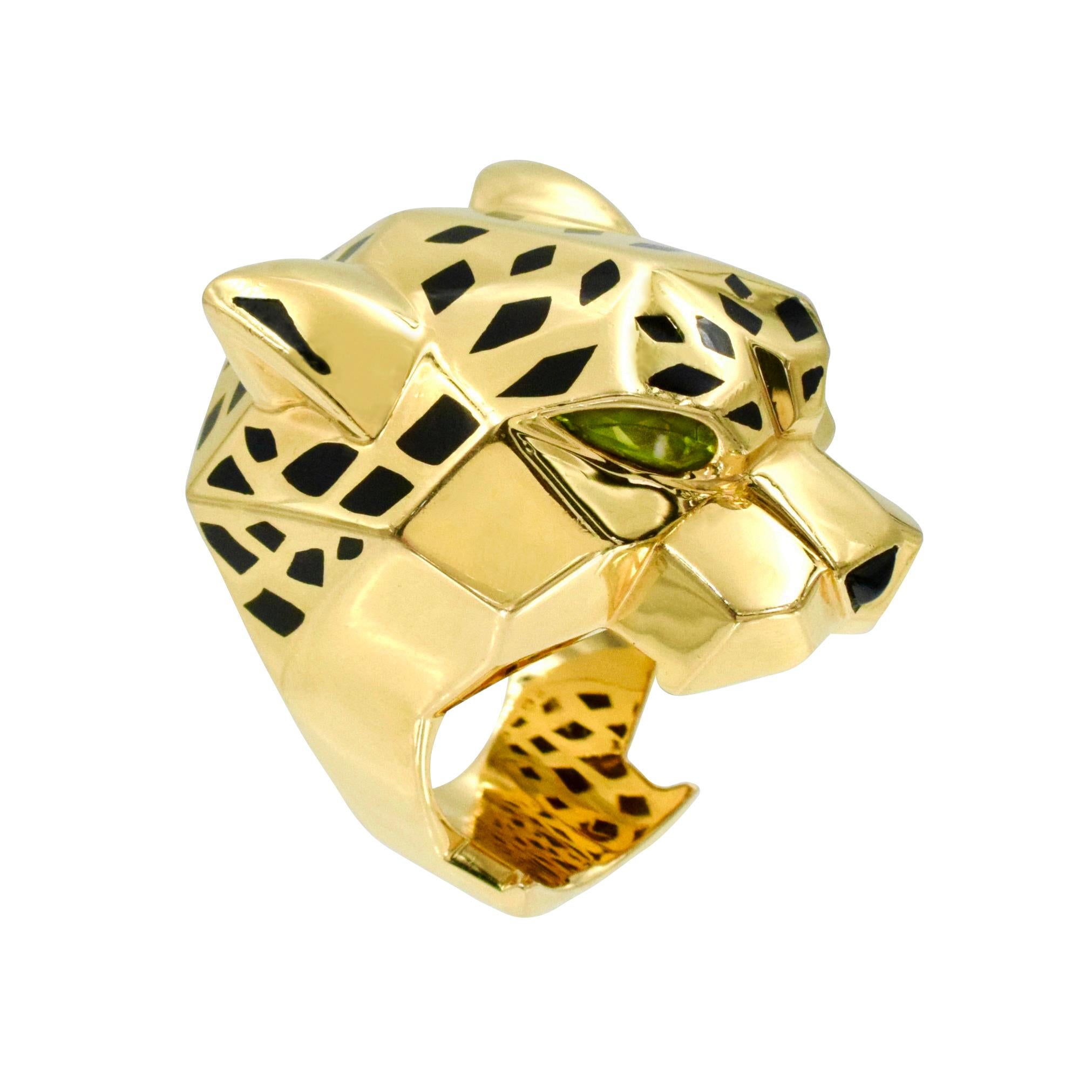 Panthère de Cartier large ring in 18K yellow gold. This substantial ring is designed as panther’s head, accented with black lacquer spots, peridot eyes and onyx nose. Measurements: 40.0mm by 30.0mm. Size: 60 / US 9. Inscribed: Cartier, 750, xxxxxxx,