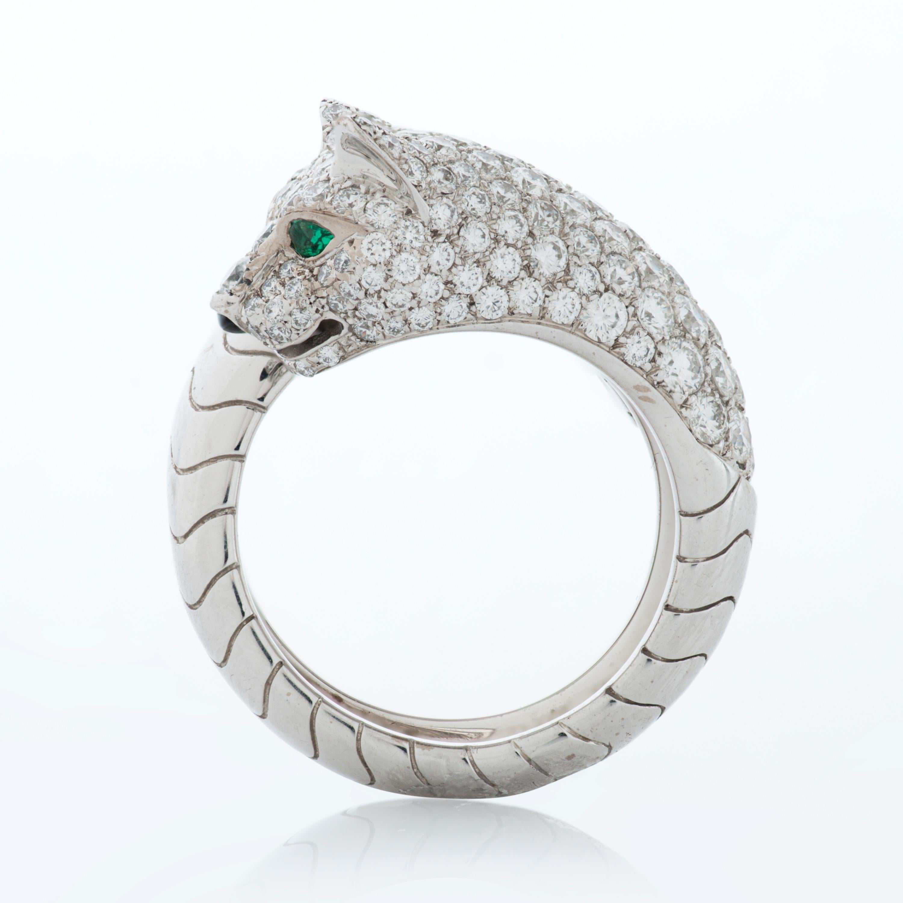 Panthere De Cartier diamond panther head bypass ring set in 18k white gold.  

This ring features approximately 2.00 carats of pave set round brilliant cut diamonds with F-G color and VS clarity, as well as emerald and onyx accents. 

The total