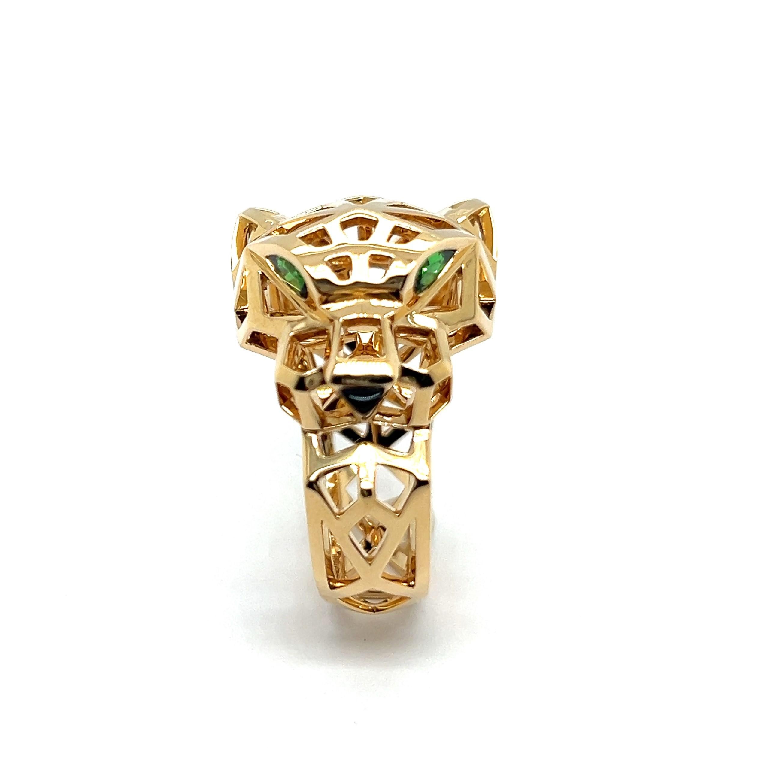 The Panthère de Cartier ring is a striking piece of artistry, blending bold geometric lines with the iconic panther motif. 

Crafted in 18K yellow gold, the ring features a sculpted panther head adorned with tsavorite garnet eyes and onyx nose,